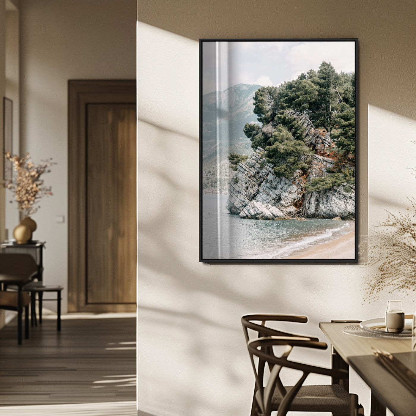 Framed photo of a rocky coastal cliff with dense greenery and calm shoreline, ideal for rustic coastal or earthy-toned home decor.