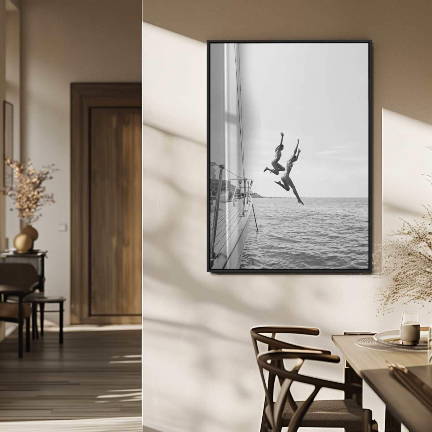 Black and white canvas wall art of two women joyfully jumping off a yacht into the sea, ideal for minimalist coastal or nautical-themed spaces.