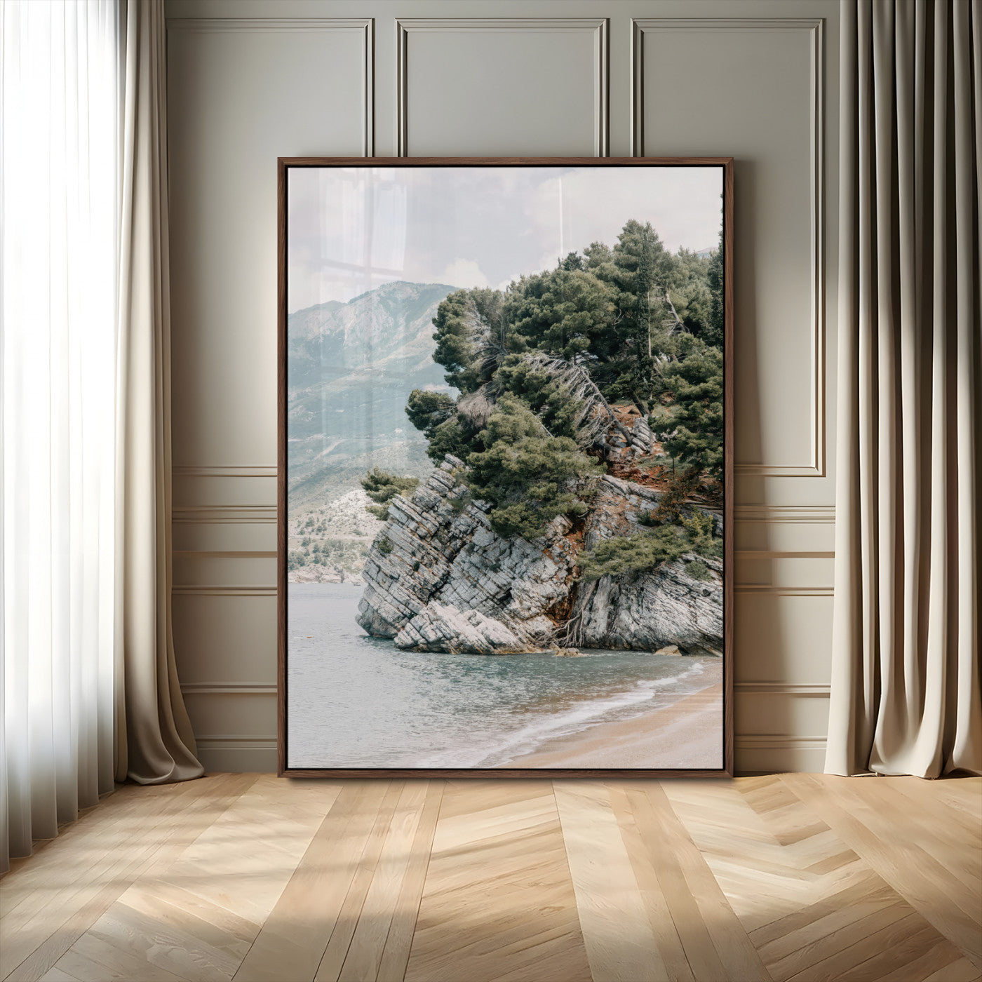Framed photo of a rocky coastal cliff with dense greenery and calm shoreline, ideal for rustic coastal or earthy-toned home decor.