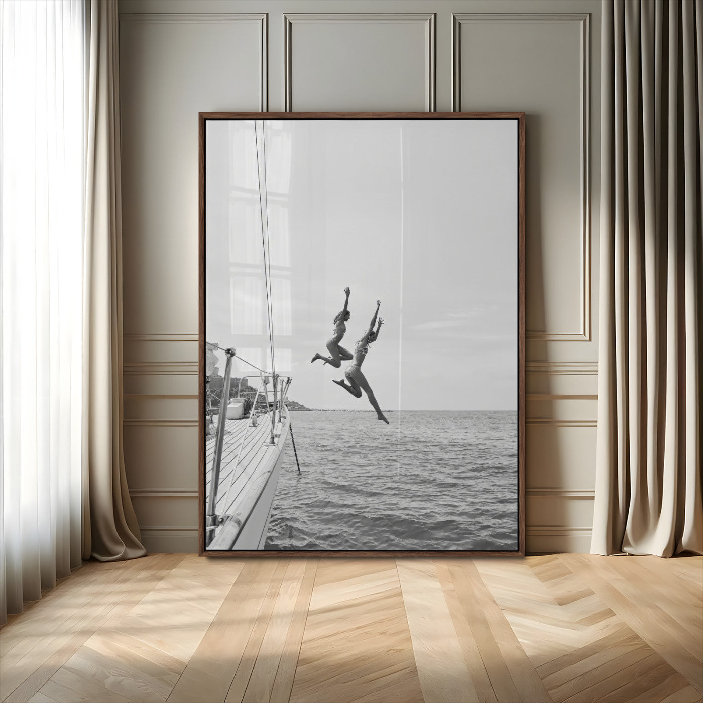 Black and white canvas wall art of two women joyfully jumping off a yacht into the sea, ideal for minimalist coastal or nautical-themed spaces.