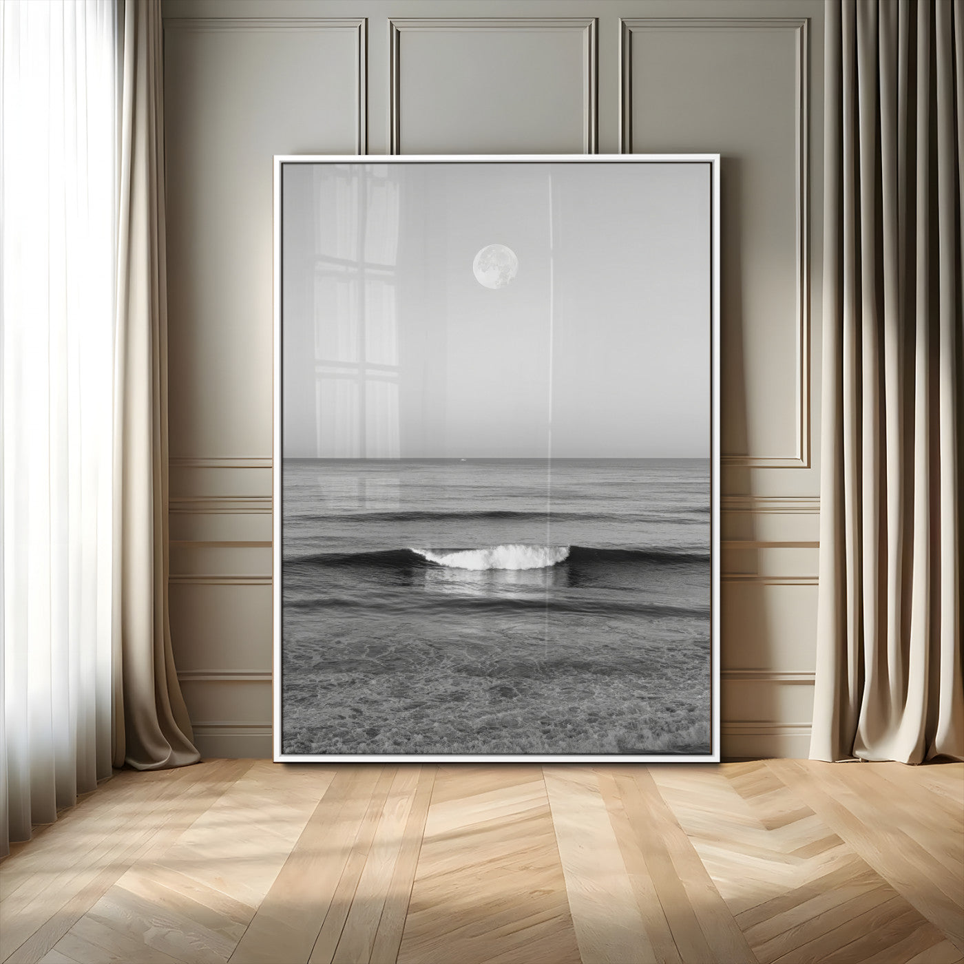Black and white wall art of a calm ocean wave beneath a full moon, ideal for minimalist or monochrome coastal decor.