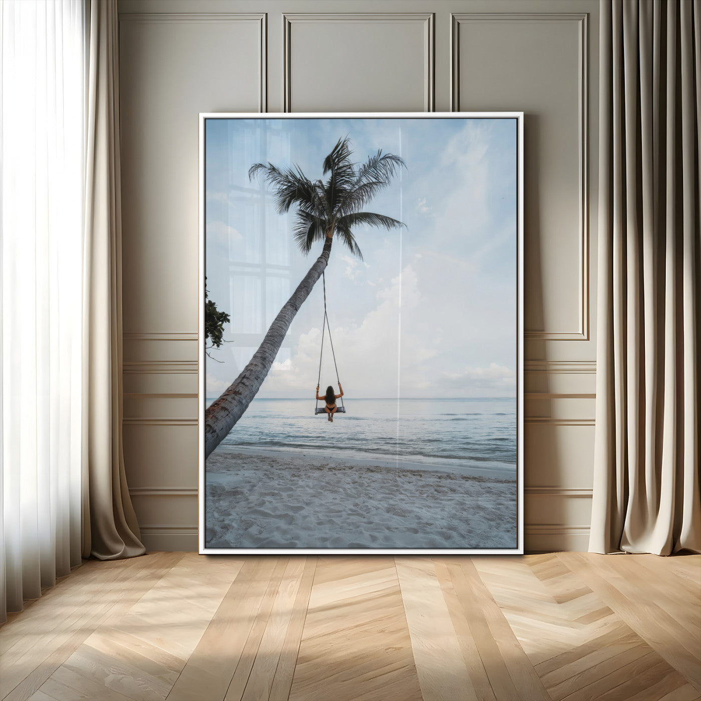 Wall art of a girl on a swing hanging from a palm tree over calm ocean waters, perfect for tropical or minimalist coastal decor.