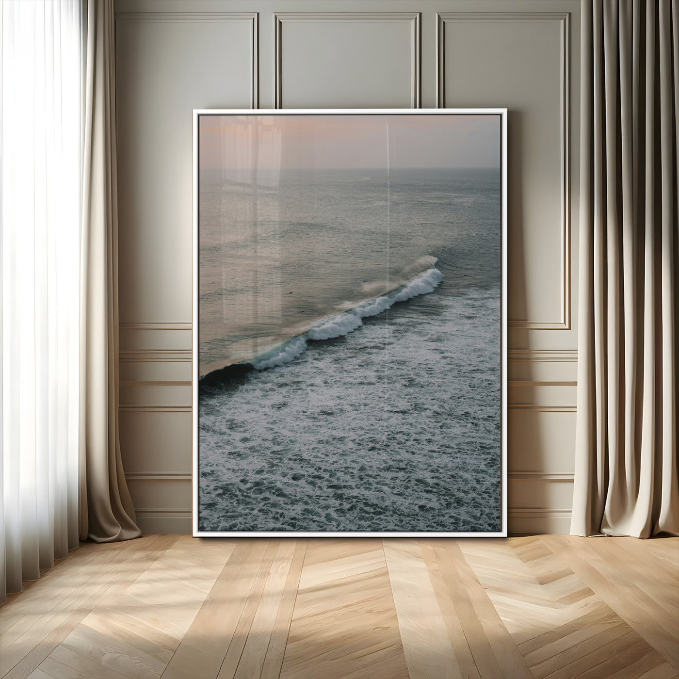 Aerial view of ocean waves rolling towards the shore under a soft sunset sky, creating a peaceful and minimalist coastal scene.