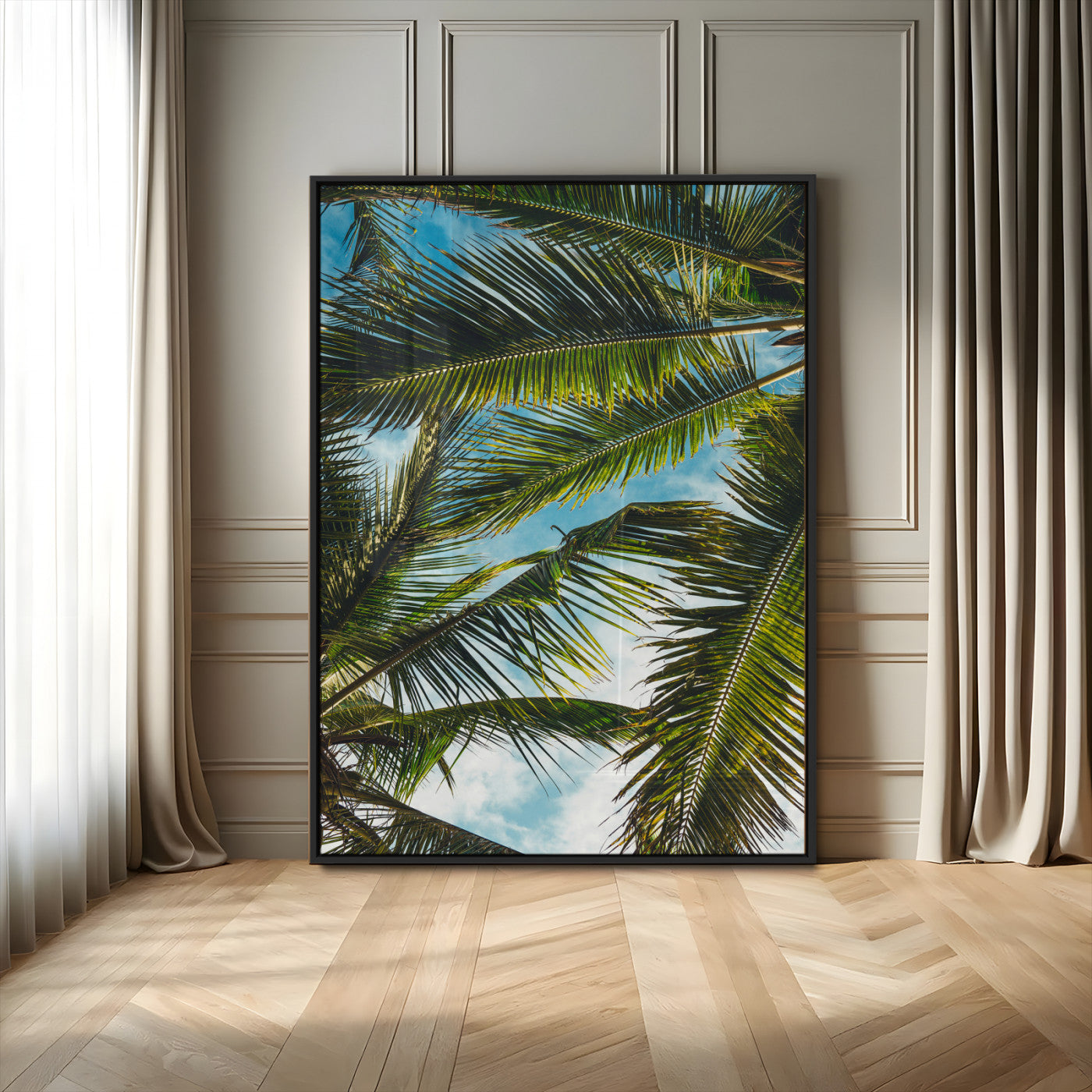 Looking up at lush green palm leaves against a bright blue sky, creating a tropical and relaxing coastal aesthetic.