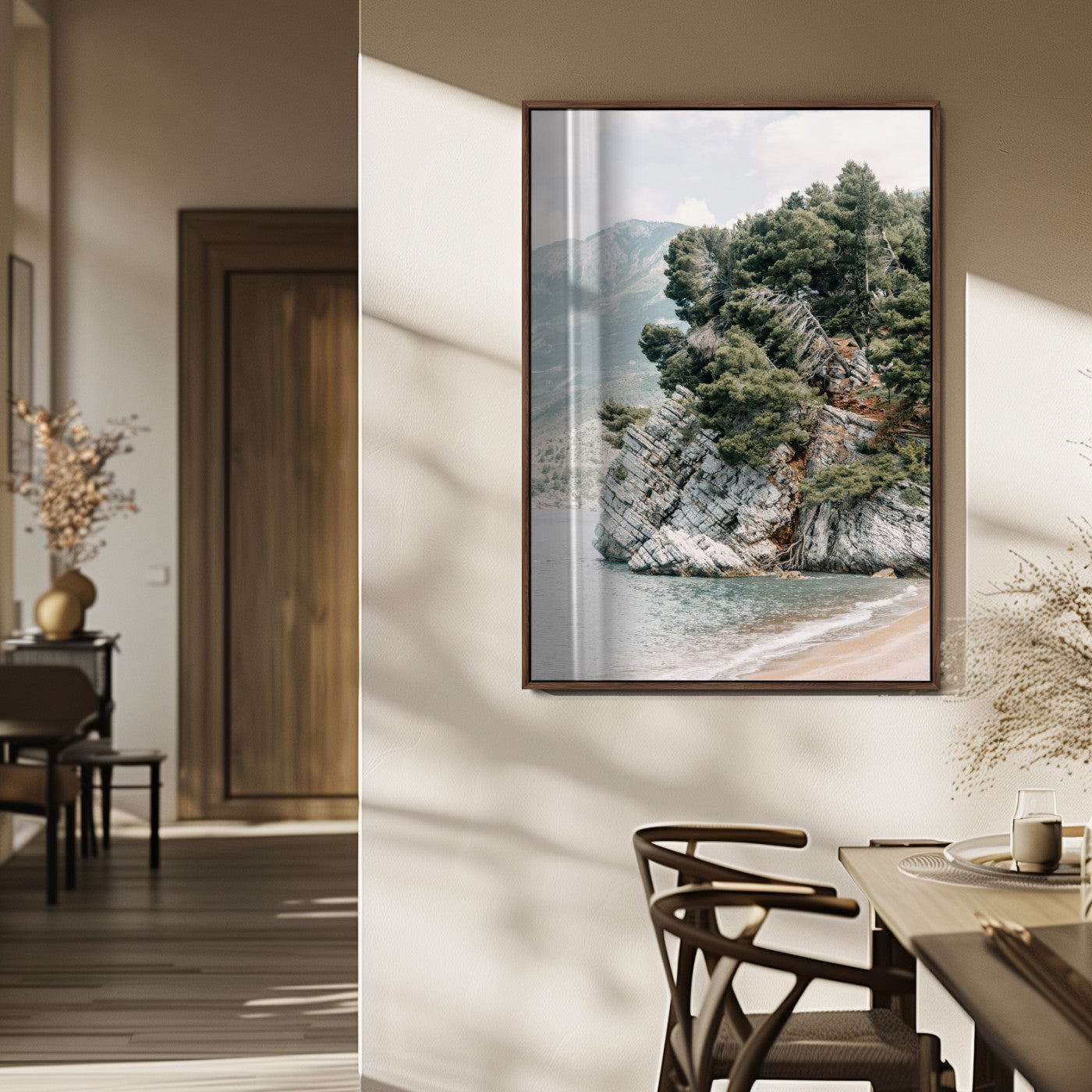 Framed photo of a rocky coastal cliff with dense greenery and calm shoreline, ideal for rustic coastal or earthy-toned home decor.