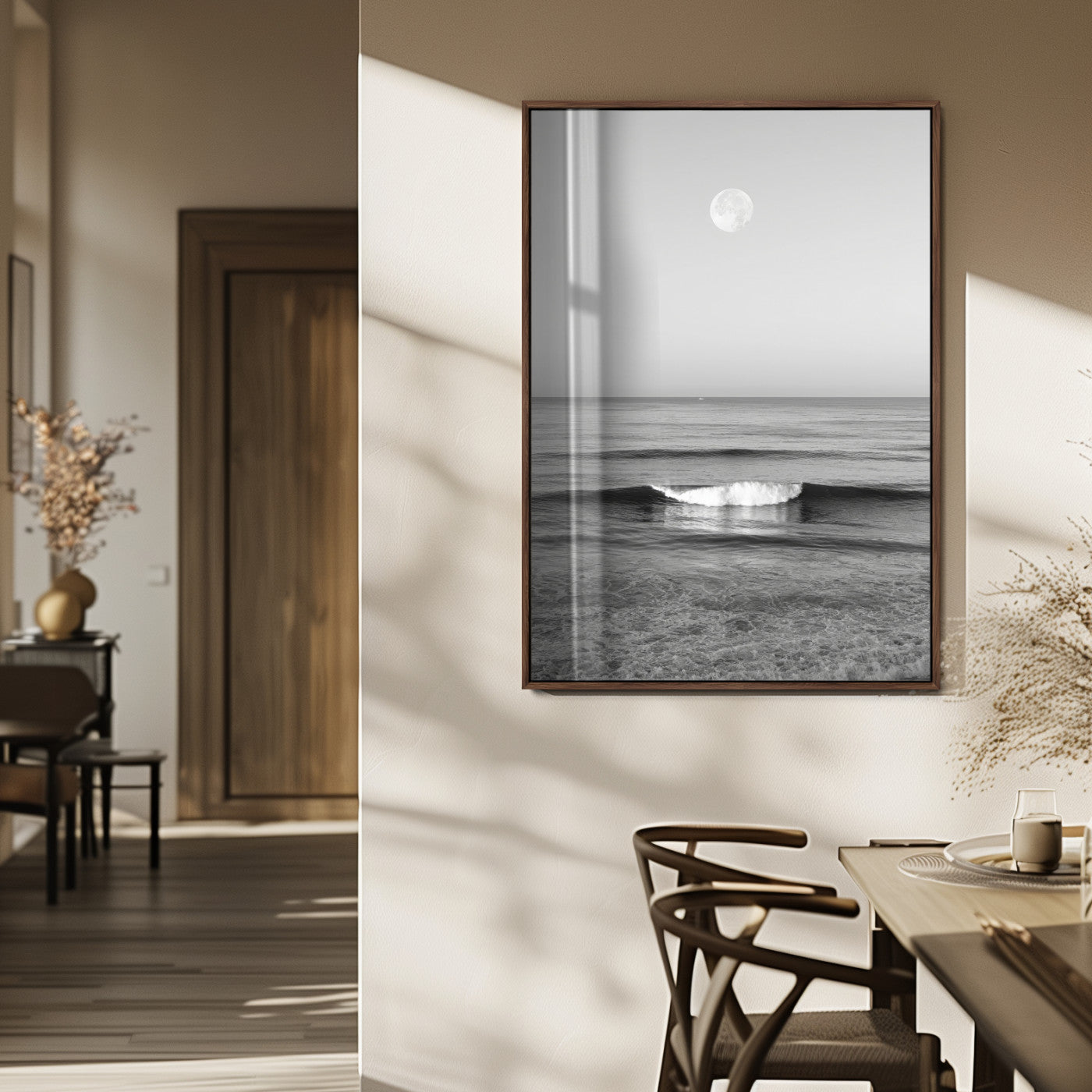 Black and white wall art of a calm ocean wave beneath a full moon, ideal for minimalist or monochrome coastal decor.