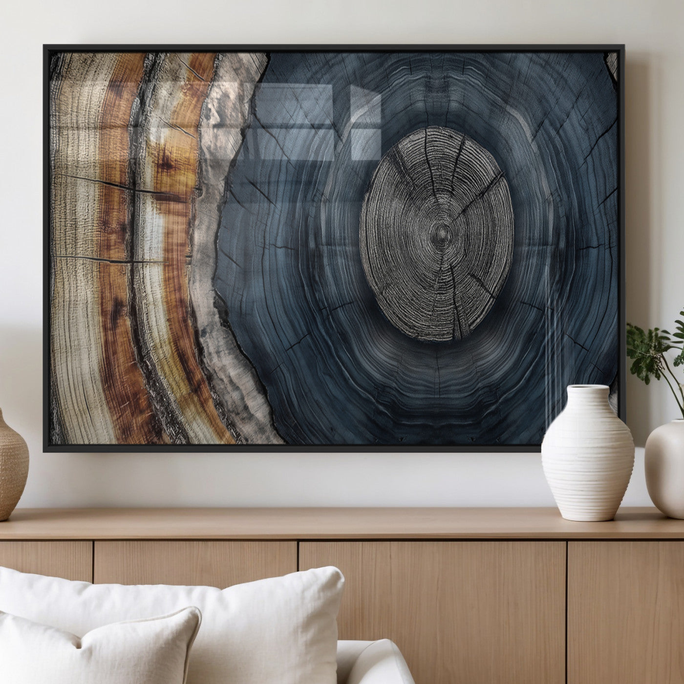 A stunning close-up of a tree trunk showing the intricate, circular growth rings, showcasing the natural textures and rich contrasts in deep blues, browns, and silvers.