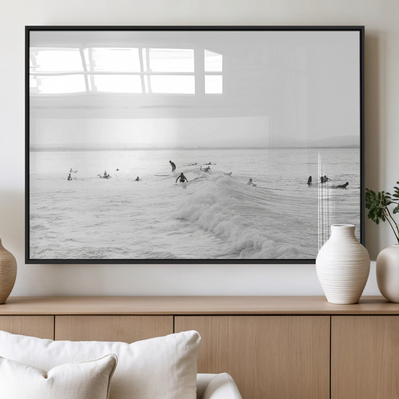 Monochrome photo of surfers riding and waiting on ocean waves, ideal for surf-themed or coastal energy wall decor.