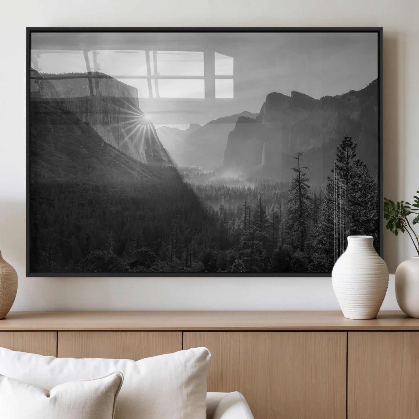 Black and white landscape of Yosemite with sun rays peeking over El Capitan, ideal for moody nature or modern rustic decor.