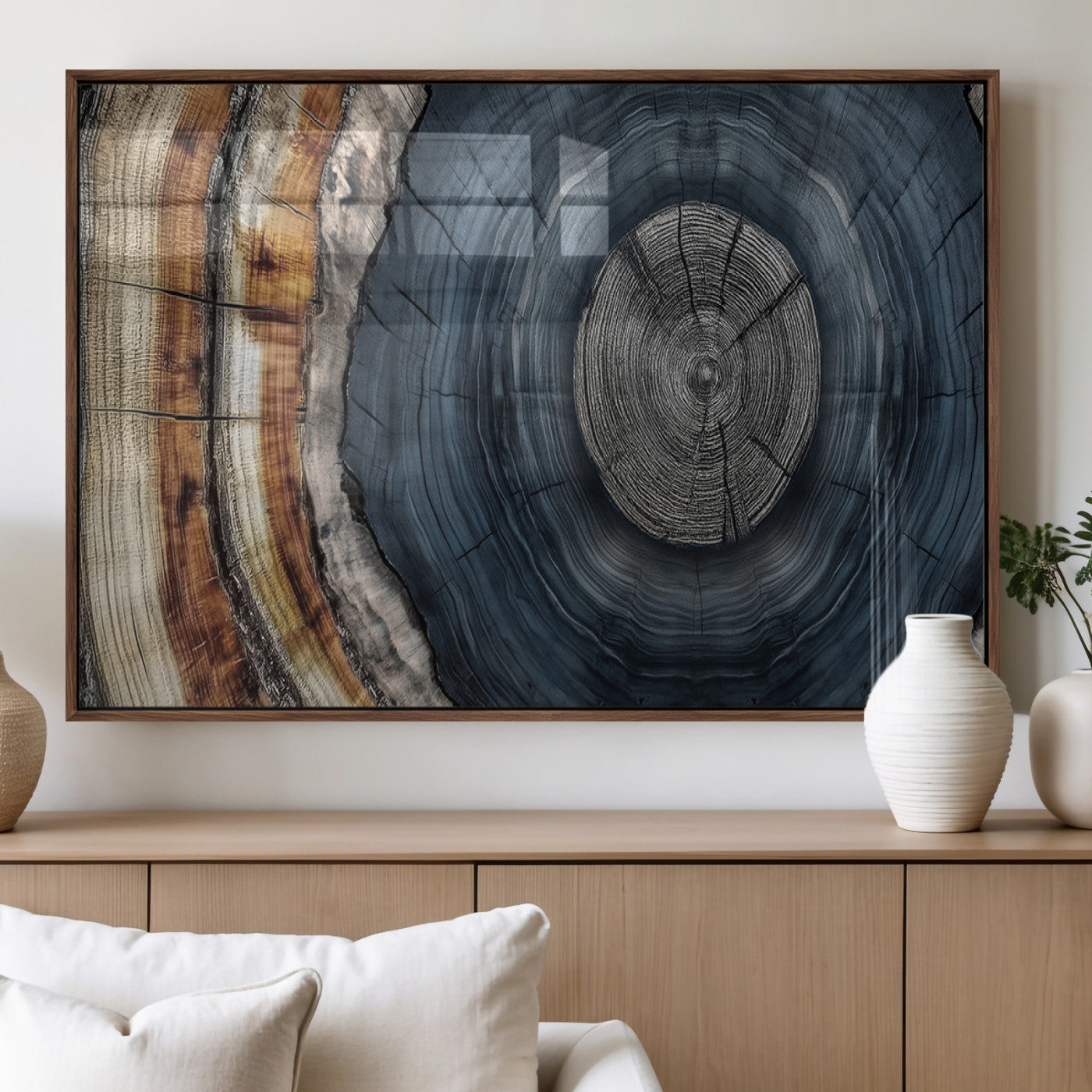 A stunning close-up of a tree trunk showing the intricate, circular growth rings, showcasing the natural textures and rich contrasts in deep blues, browns, and silvers.