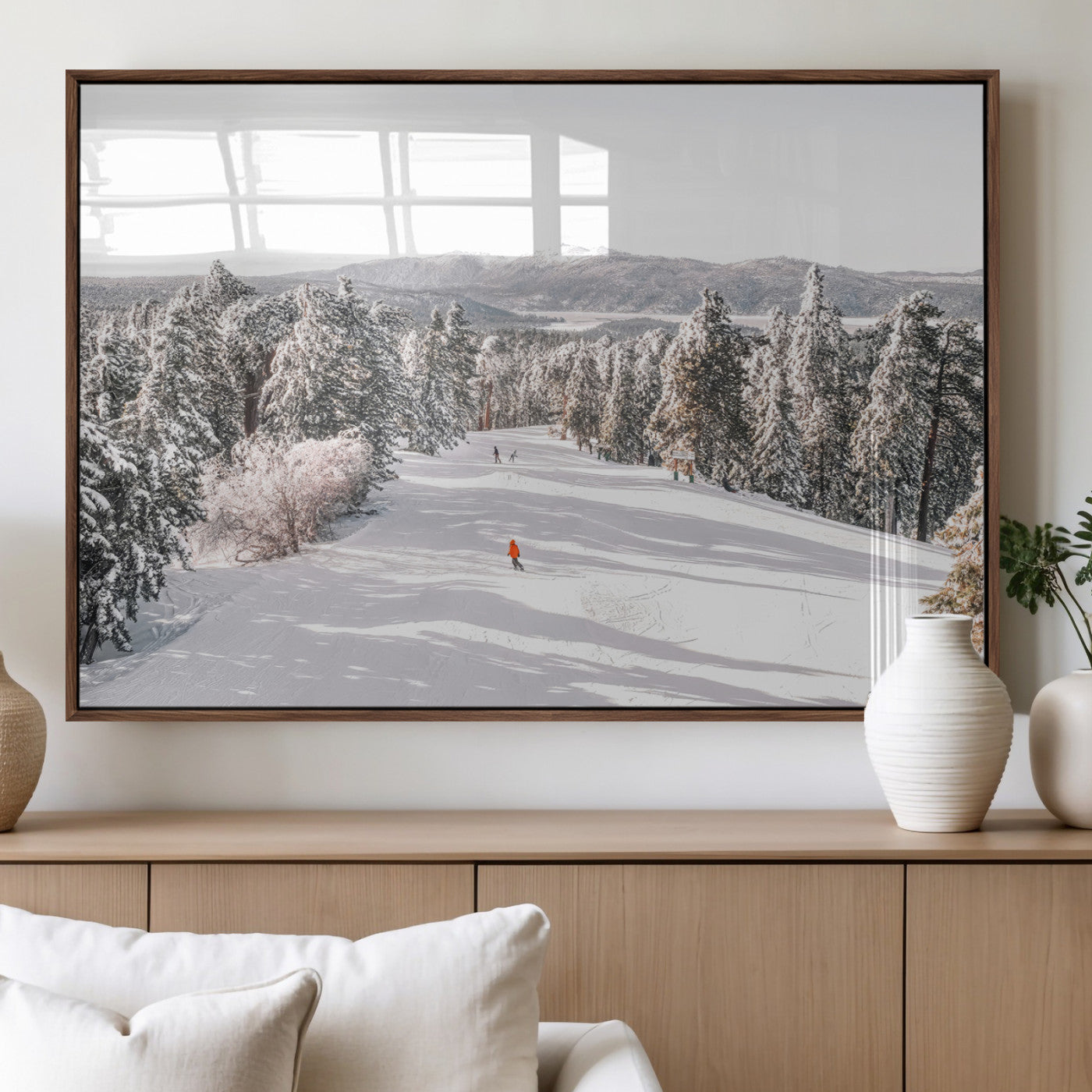 Bright ski trail lined with snow-covered pines and a skier in orange, perfect for alpine adventure or winter sports-inspired decor.