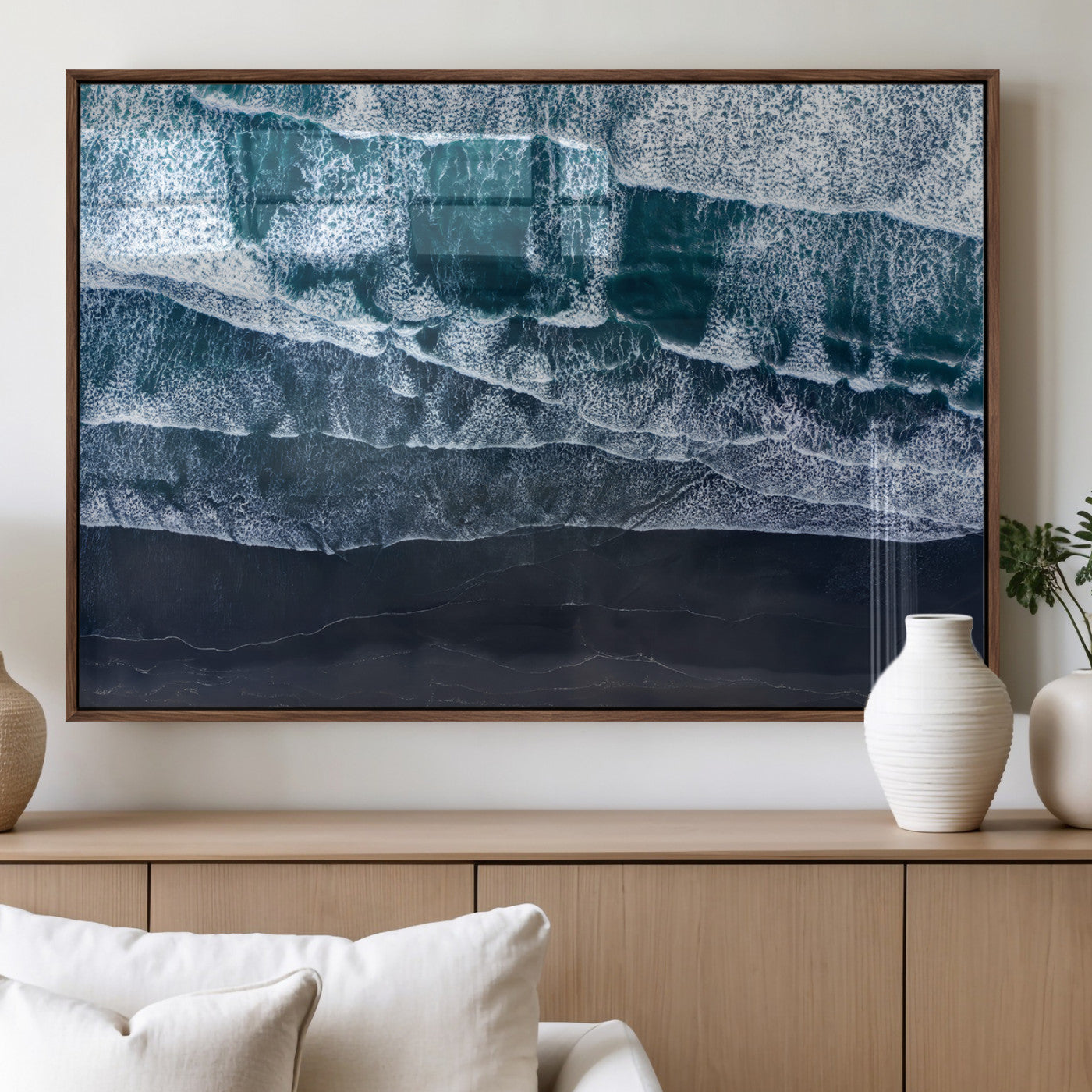 Canvas of aerial ocean waves crashing onto a black sand beach in moody tones, ideal for modern coastal or minimalist home decor.
