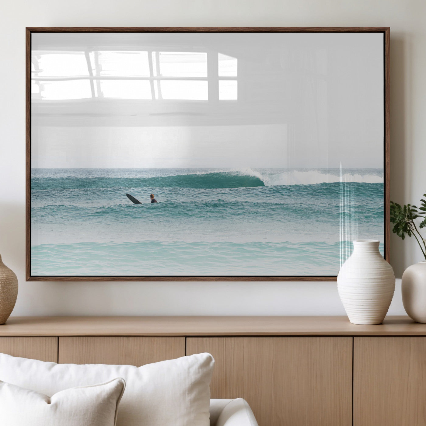 Minimalist photo of a lone surfer on calm aqua waves under bright sky, perfect for Scandinavian coastal or serene ocean-inspired home decor.