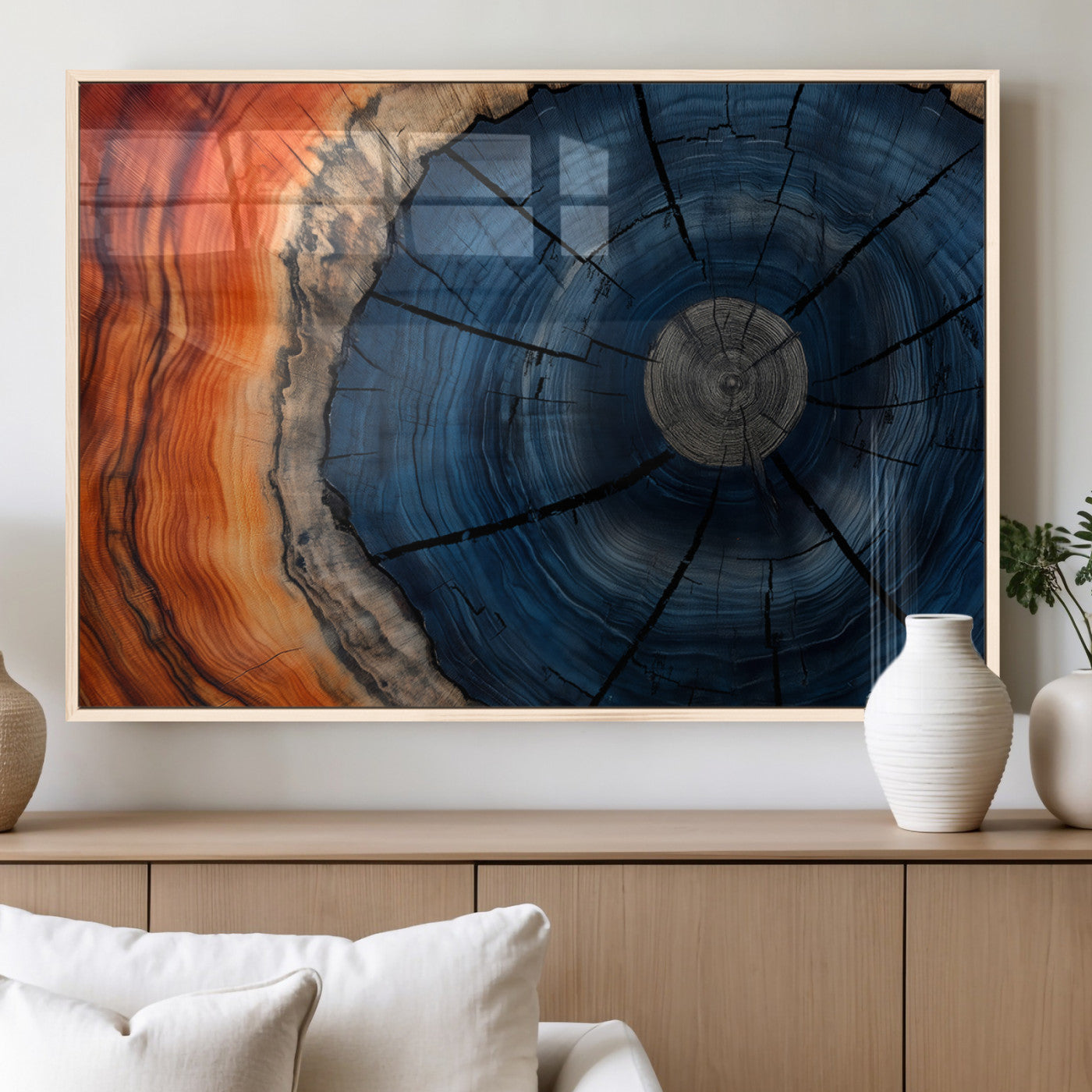 A captivating close-up of a tree trunk, showcasing its concentric rings in rich shades of blue, orange, and brown, highlighting the organic patterns of natural wood.