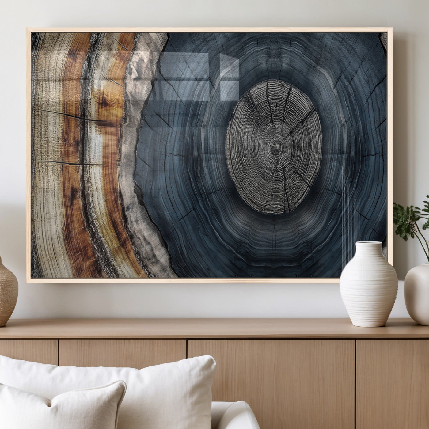 A stunning close-up of a tree trunk showing the intricate, circular growth rings, showcasing the natural textures and rich contrasts in deep blues, browns, and silvers.