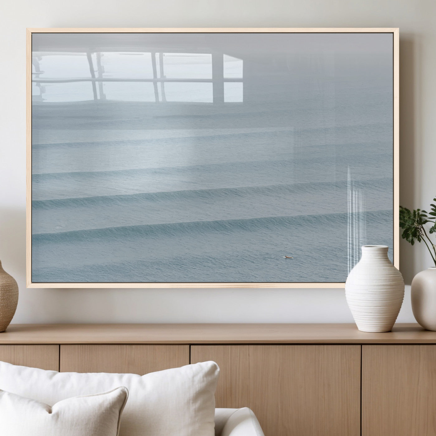 Framed canvas of repeating ocean waves with a distant solo surfer, ideal for minimalist ocean or calm coastal wall decor.
