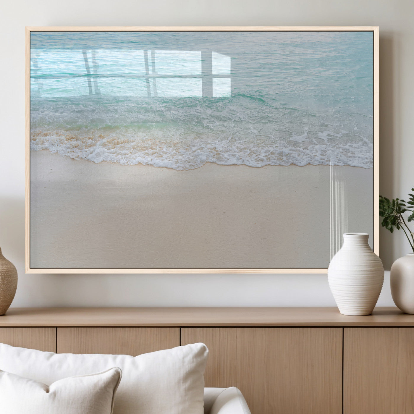 Soft shoreline with gentle aqua waves on smooth sand, ideal for minimalist coastal or pastel ocean-inspired home wall decor.