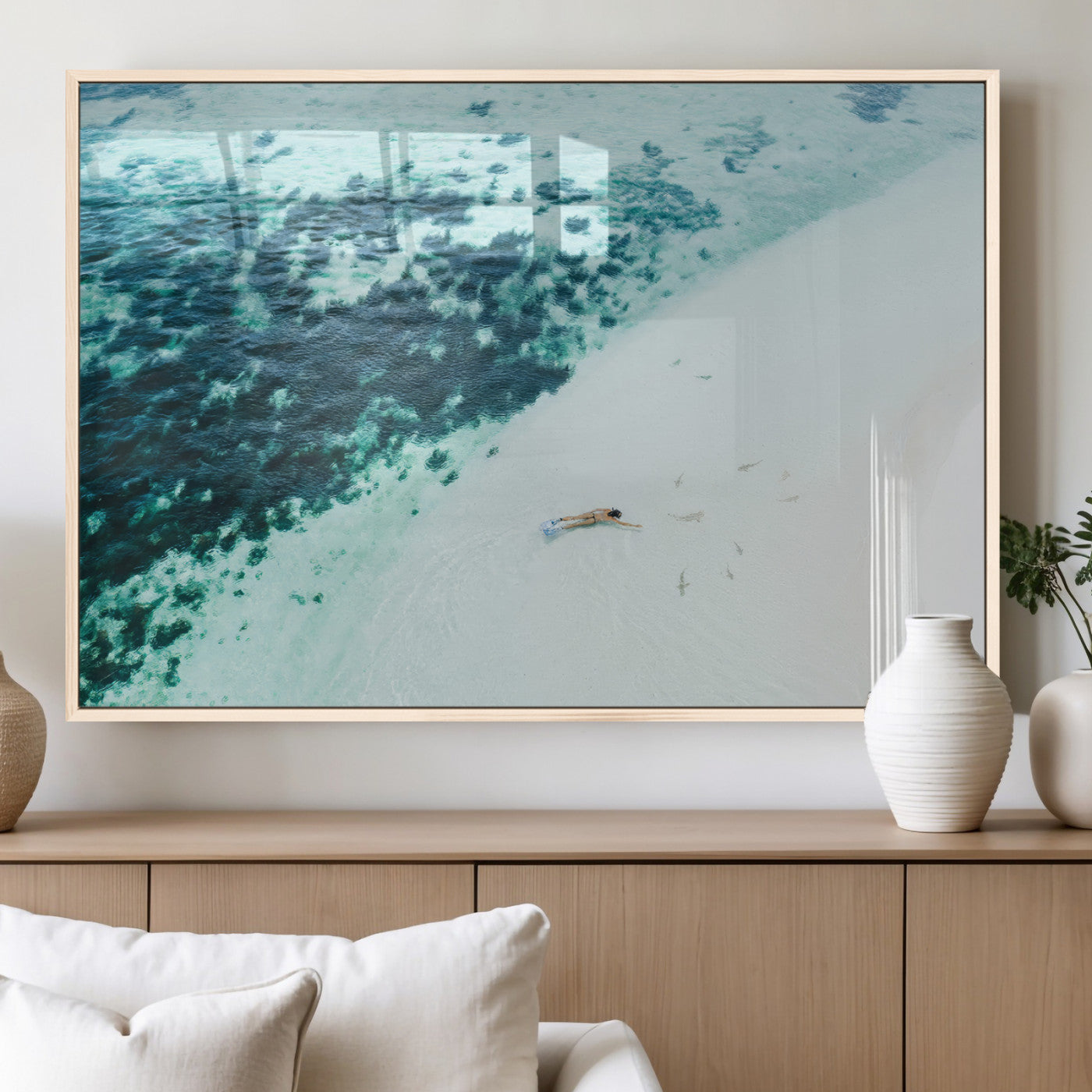 Canvas featuring an aerial view of a swimmer in shallow turquoise waters with coral patterns, ideal for tropical coastal home decor.