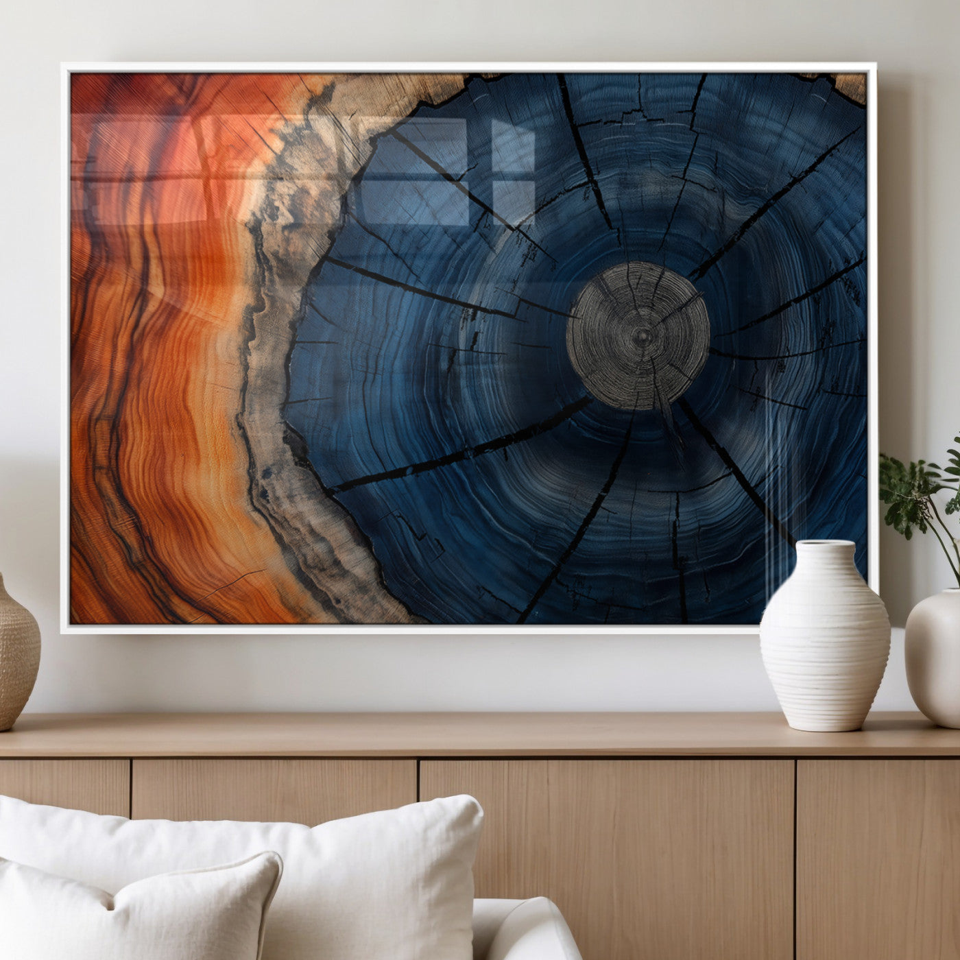 A captivating close-up of a tree trunk, showcasing its concentric rings in rich shades of blue, orange, and brown, highlighting the organic patterns of natural wood.