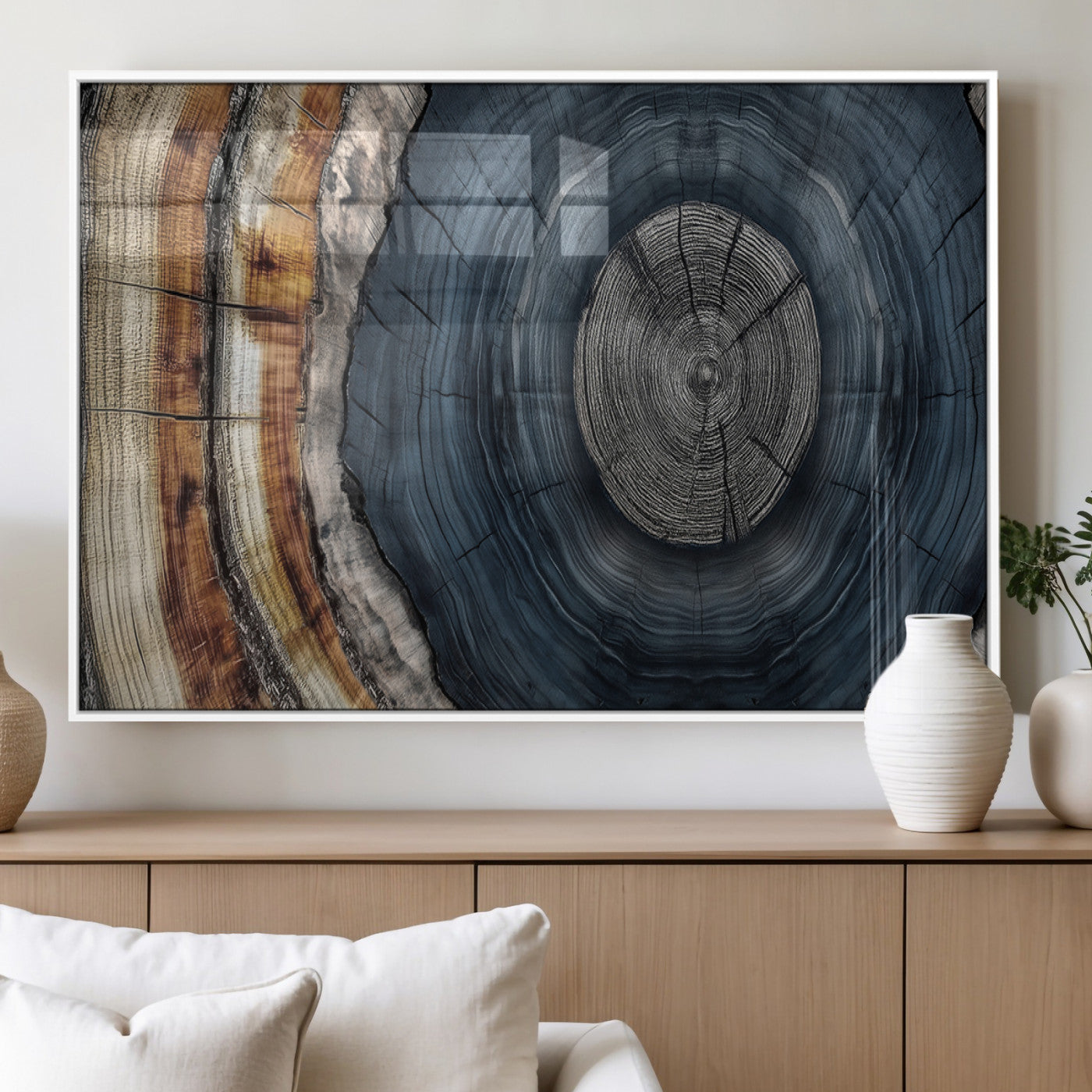 A stunning close-up of a tree trunk showing the intricate, circular growth rings, showcasing the natural textures and rich contrasts in deep blues, browns, and silvers.