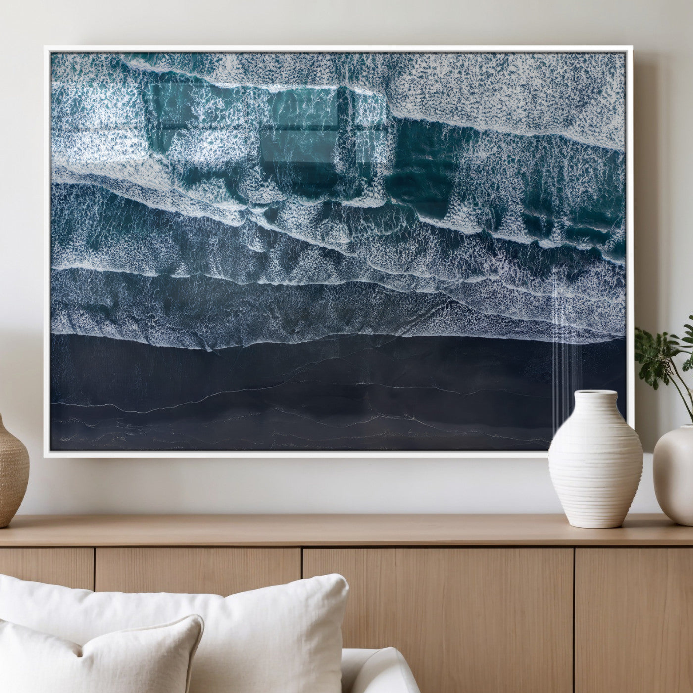 Canvas of aerial ocean waves crashing onto a black sand beach in moody tones, ideal for modern coastal or minimalist home decor.
