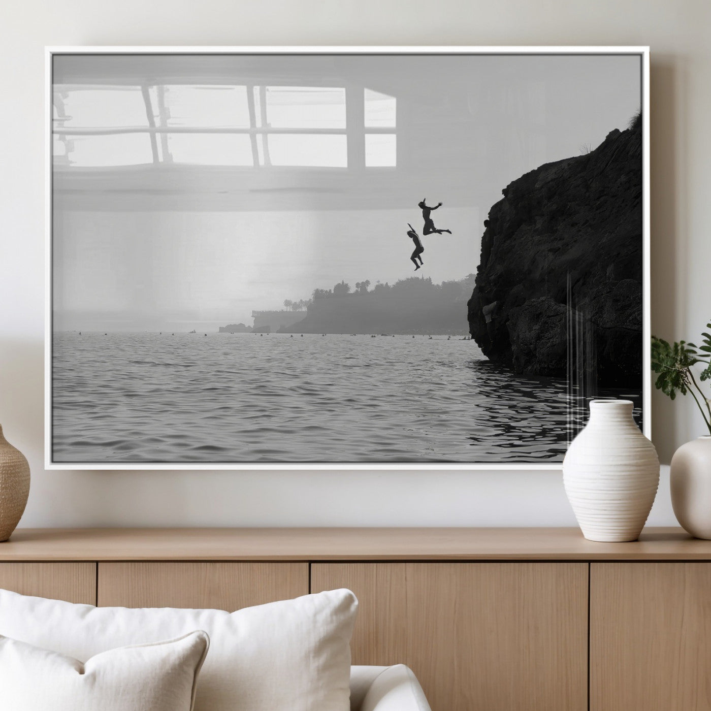 Black and white canvas of two figures cliff jumping into the sea, captured with moody tones, ideal for modern coastal or adventure-themed home decor. 2/2