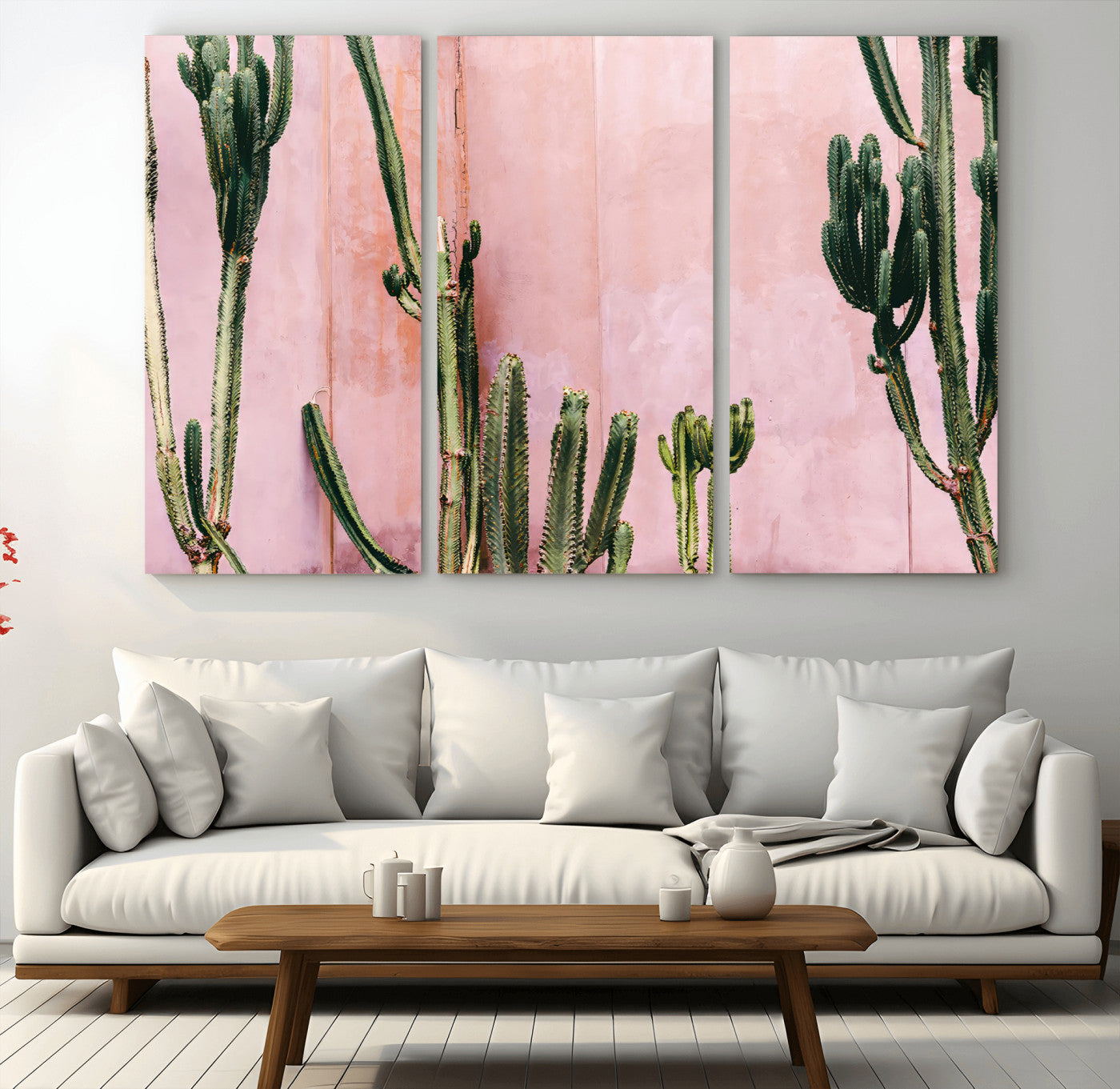 Framed canvas of tall green cacti against a soft pink wall, ideal for modern desert or colorful southwest-inspired home decor.
