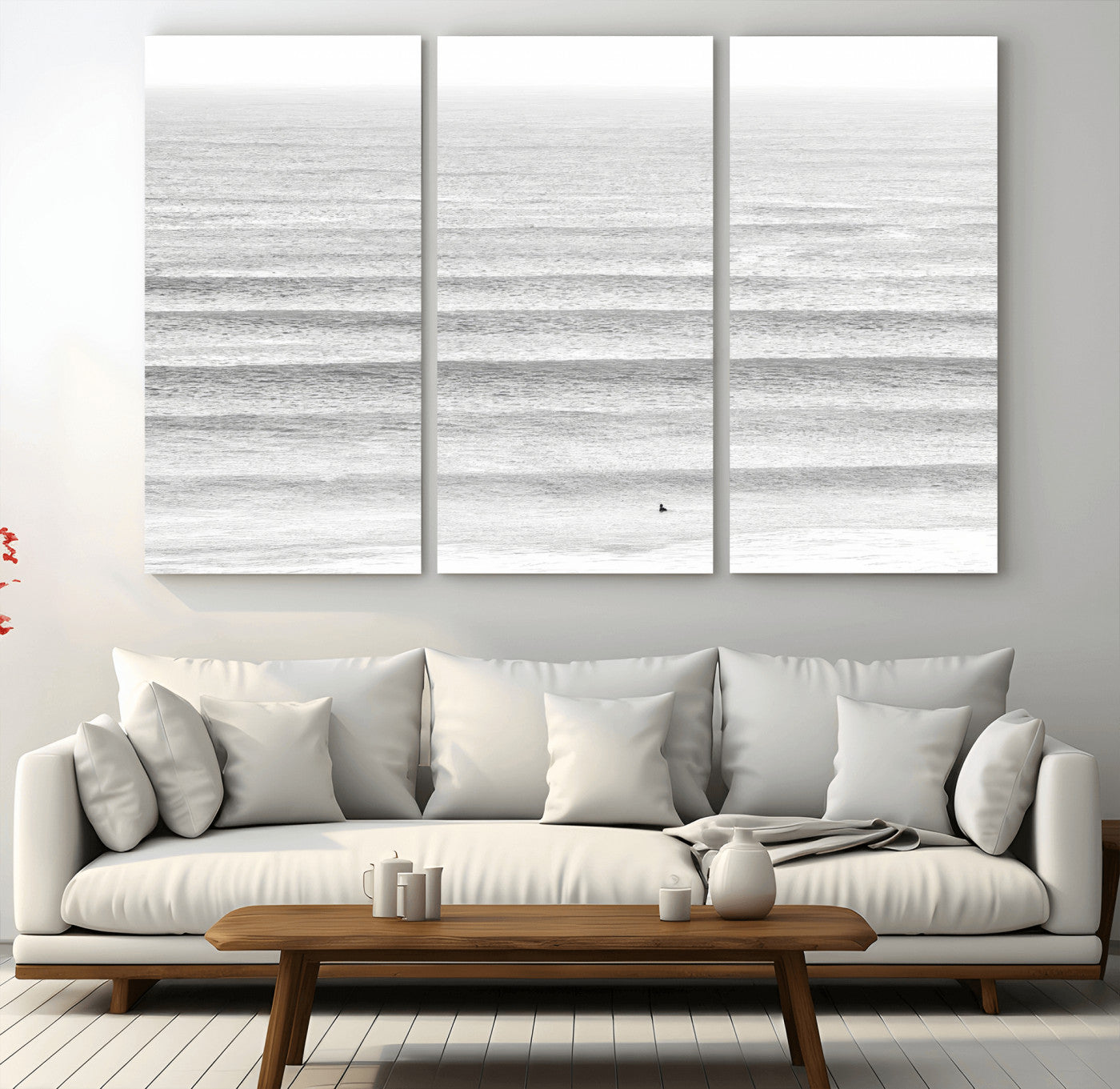 Monochrome photo of a lone surfer in calm layered waves, perfect for minimalist coastal or moody ocean-inspired wall decoration.