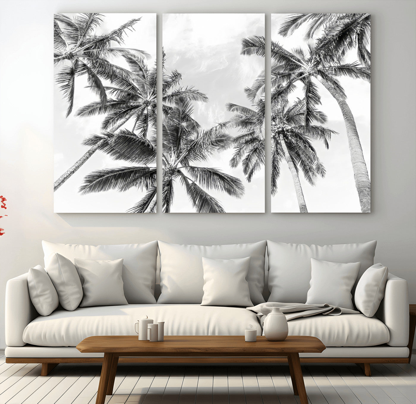 Black and white tropical palm trees viewed from below, swaying gently against a bright sky, creating a serene and elegant coastal atmosphere.