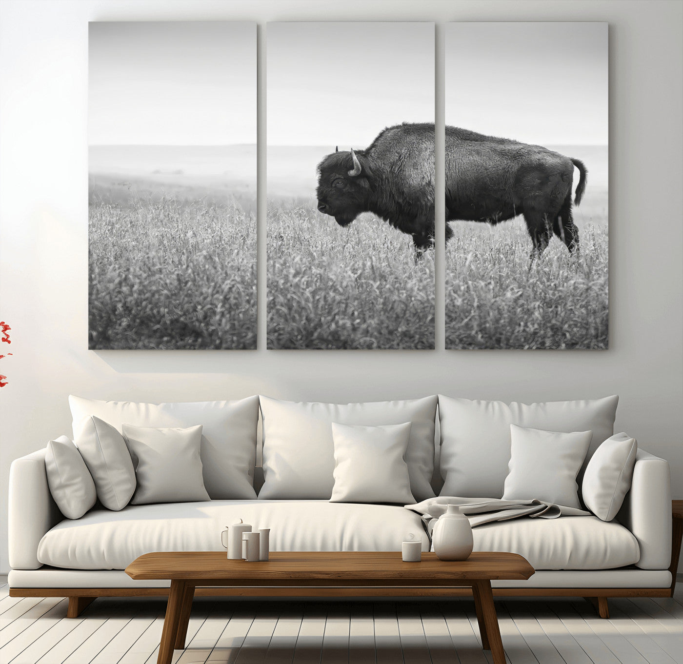 A black and white photograph of a majestic bison standing in a vast grassy prairie, evoking a sense of wilderness and strength.