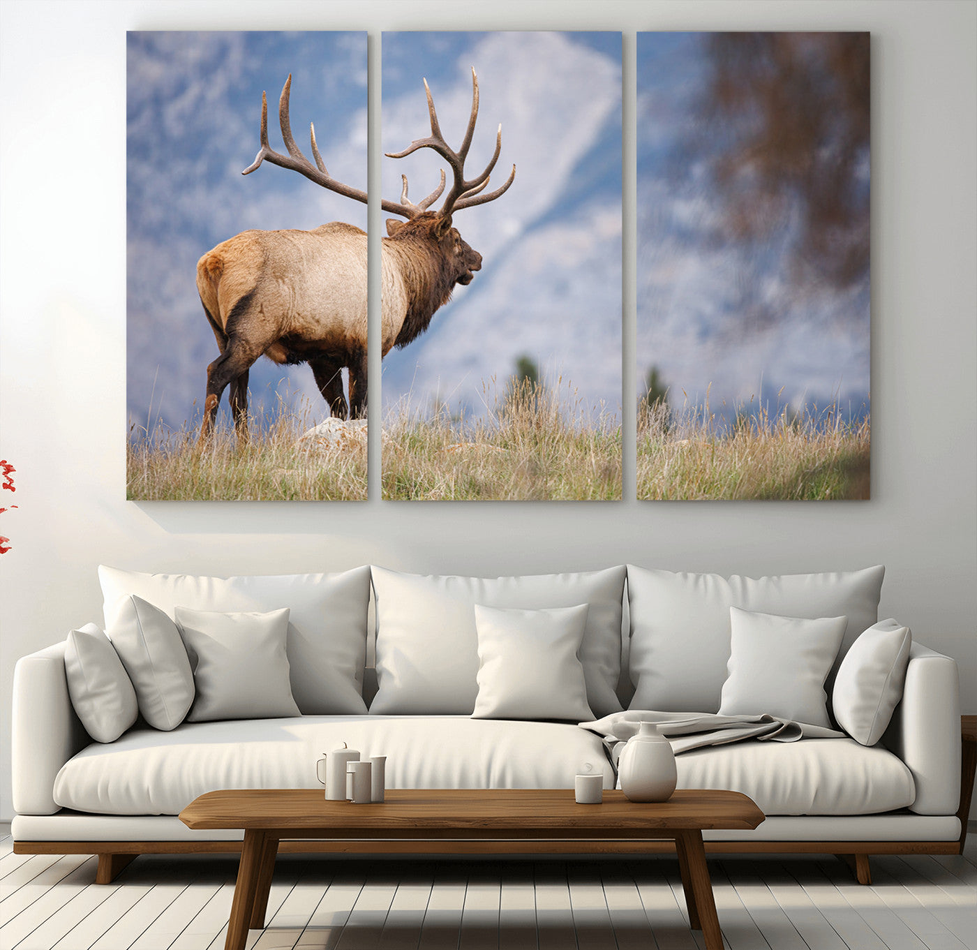 Elk with antlers standing on grass with mountain background, ideal for rustic, cabin, or lodge-inspired wall decor.
