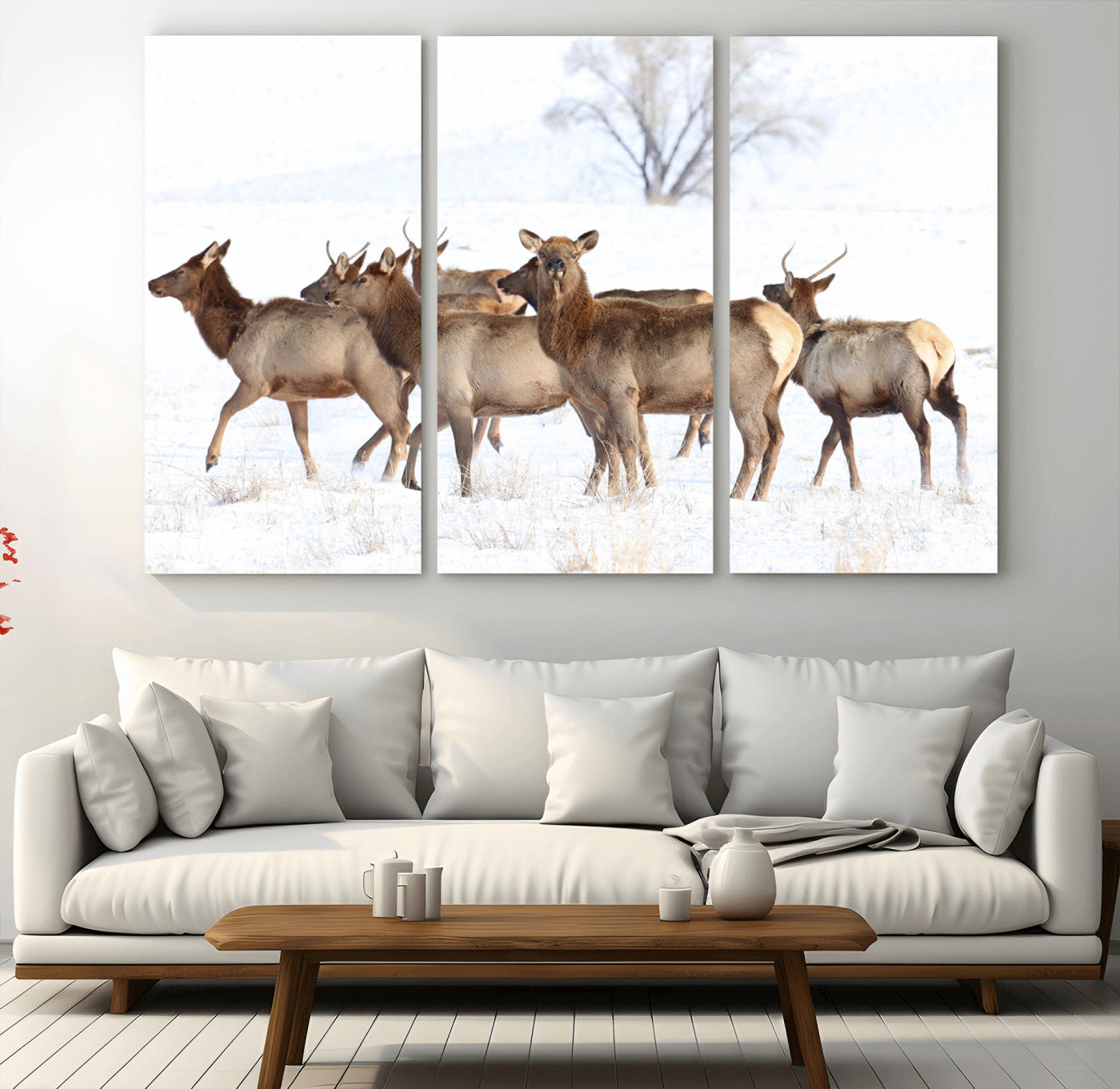 A group of elk standing on snowy terrain with a tree in the background, perfect for rustic or lodge-style winter wall decor.