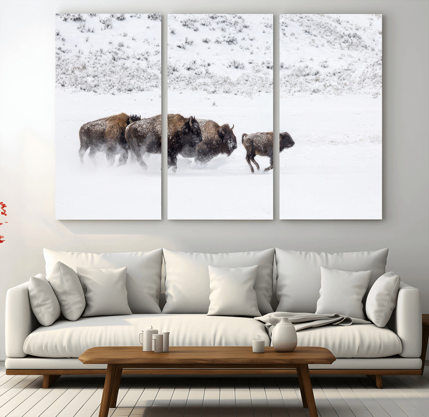 Bison herd running through a snowy open field with mountain backdrop, perfect for rustic or western-themed wall decoration.