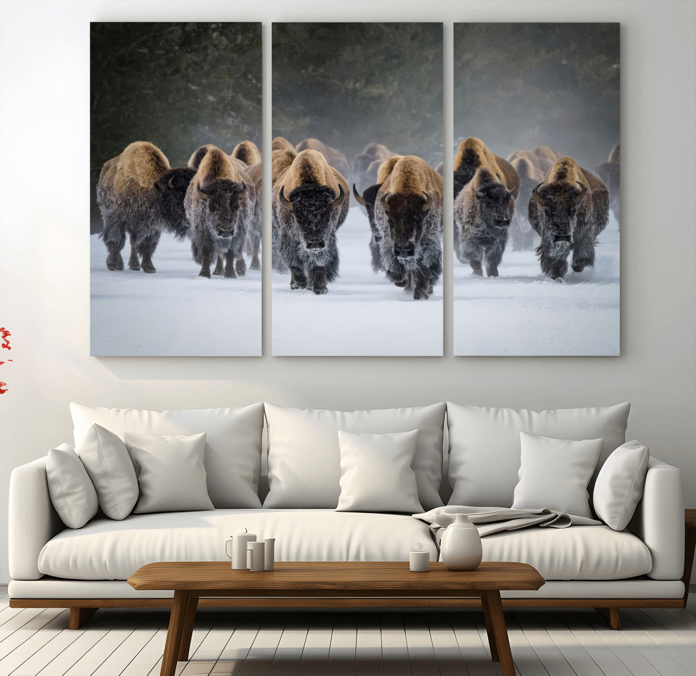 A herd of American bisons walking through deep snow in a forest, evoking a powerful rustic wilderness mood for western-style interiors.