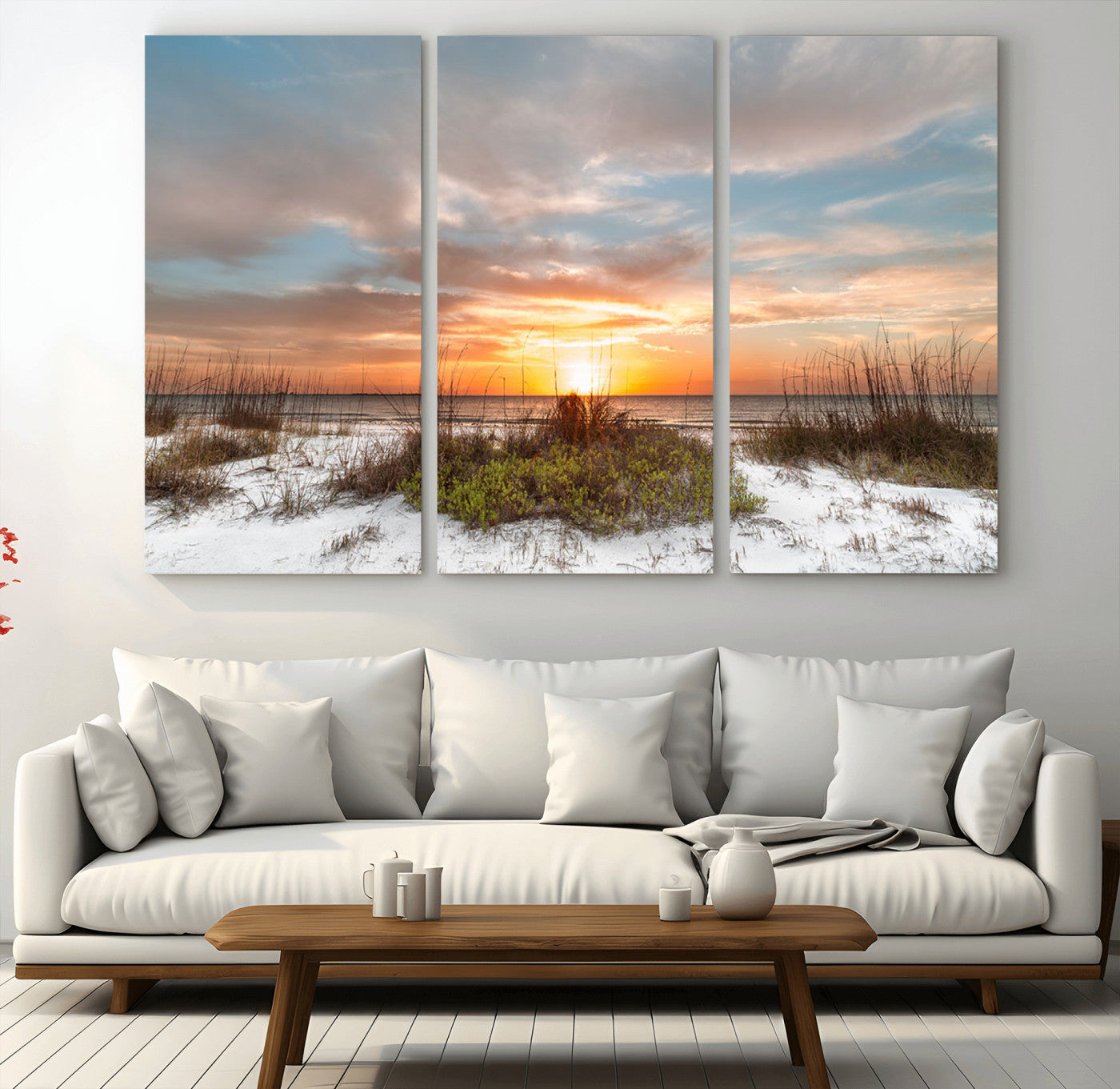 A tranquil beach scene featuring golden sunset hues over the water, with grasses in the foreground and a peaceful, serene atmosphere.