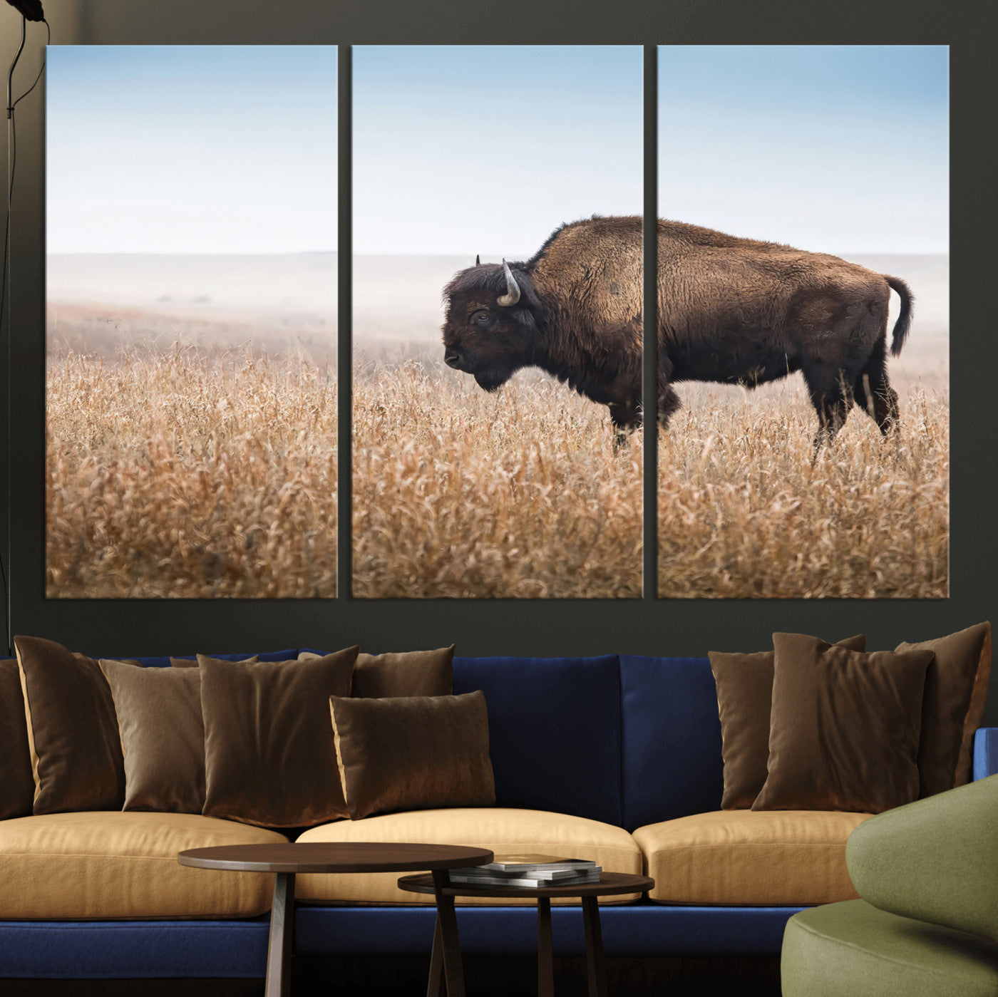 A majestic bison standing in an open prairie field, its strong form blending into the golden grass under a vast blue sky, evoking the wild spirit of the American plains.