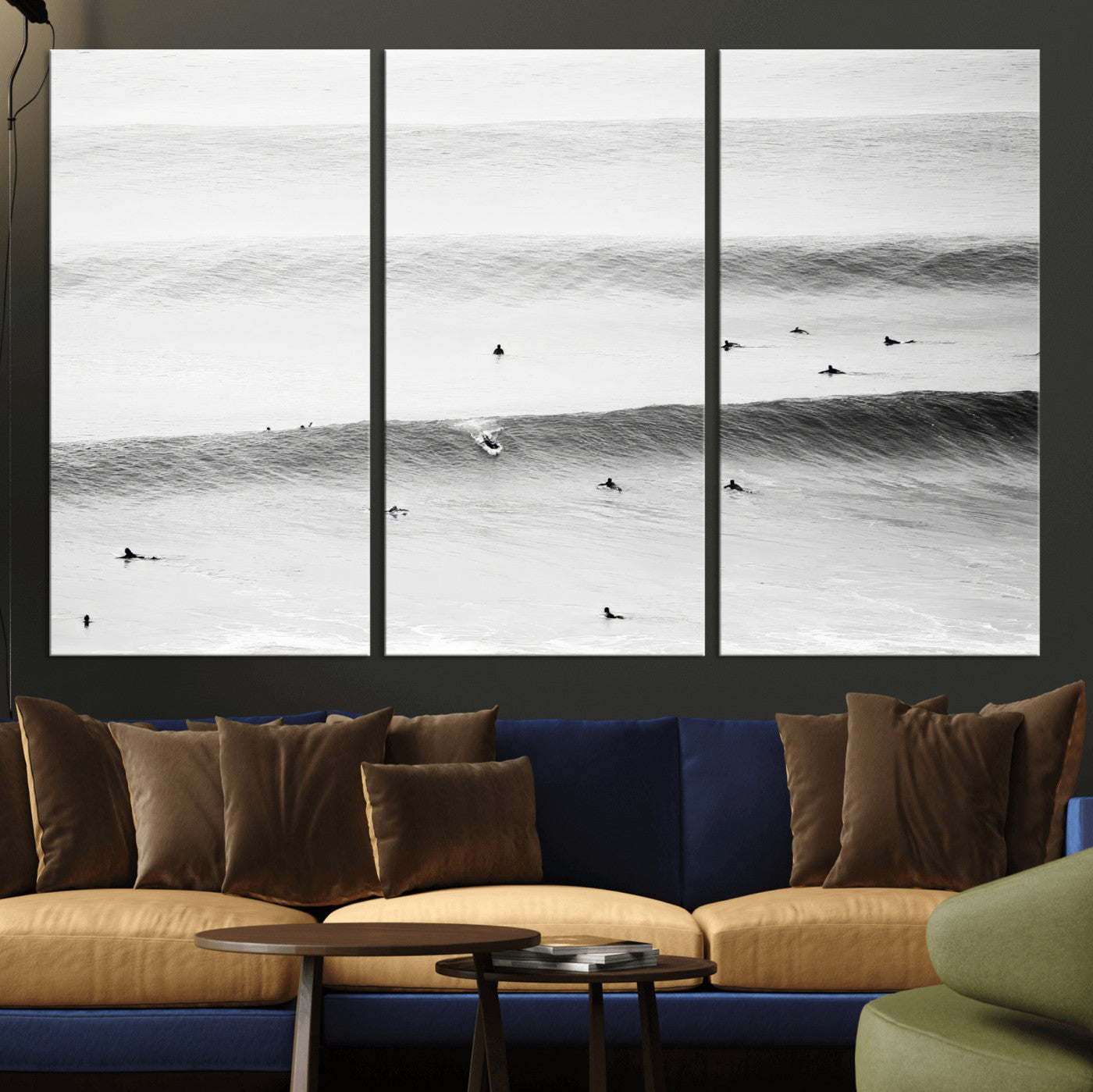 A monochrome photograph of swimmers gliding through gentle ocean waves, evoking a sense of calm and movement.