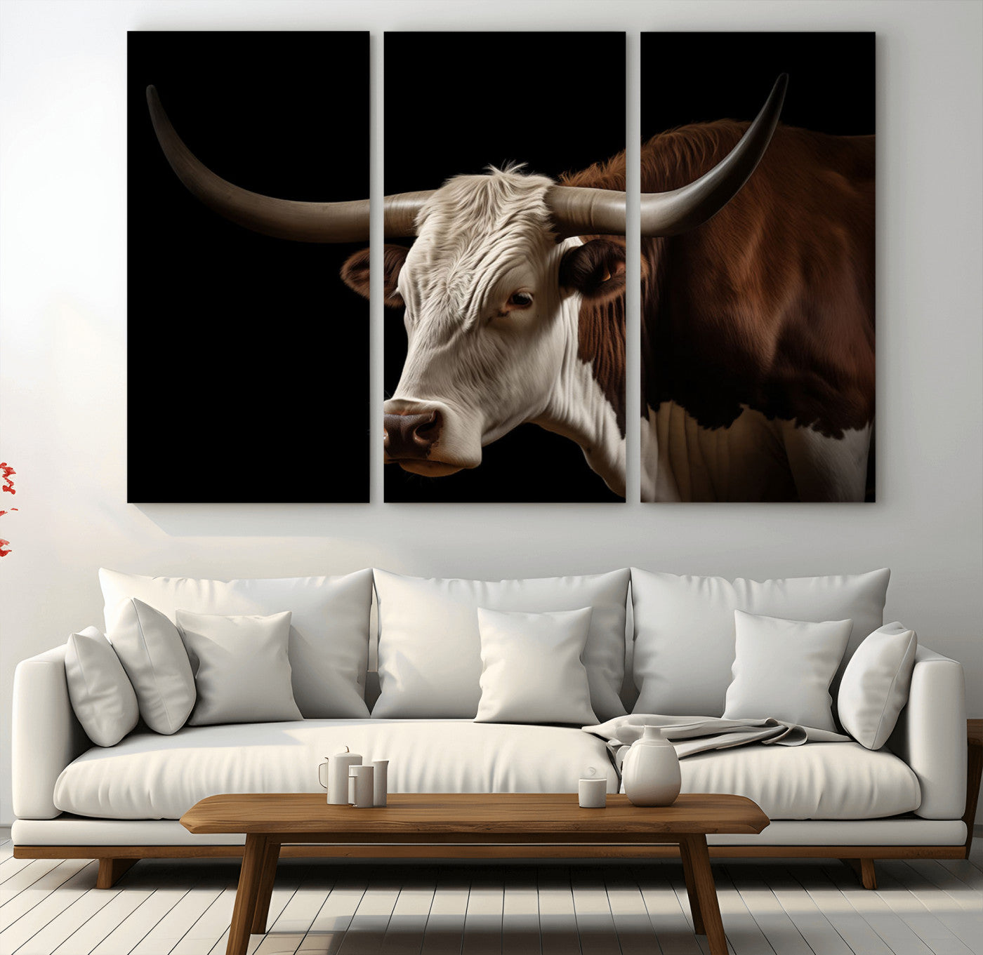 "Close-up of a brown and white longhorn cow with prominent curved horns against a black background."