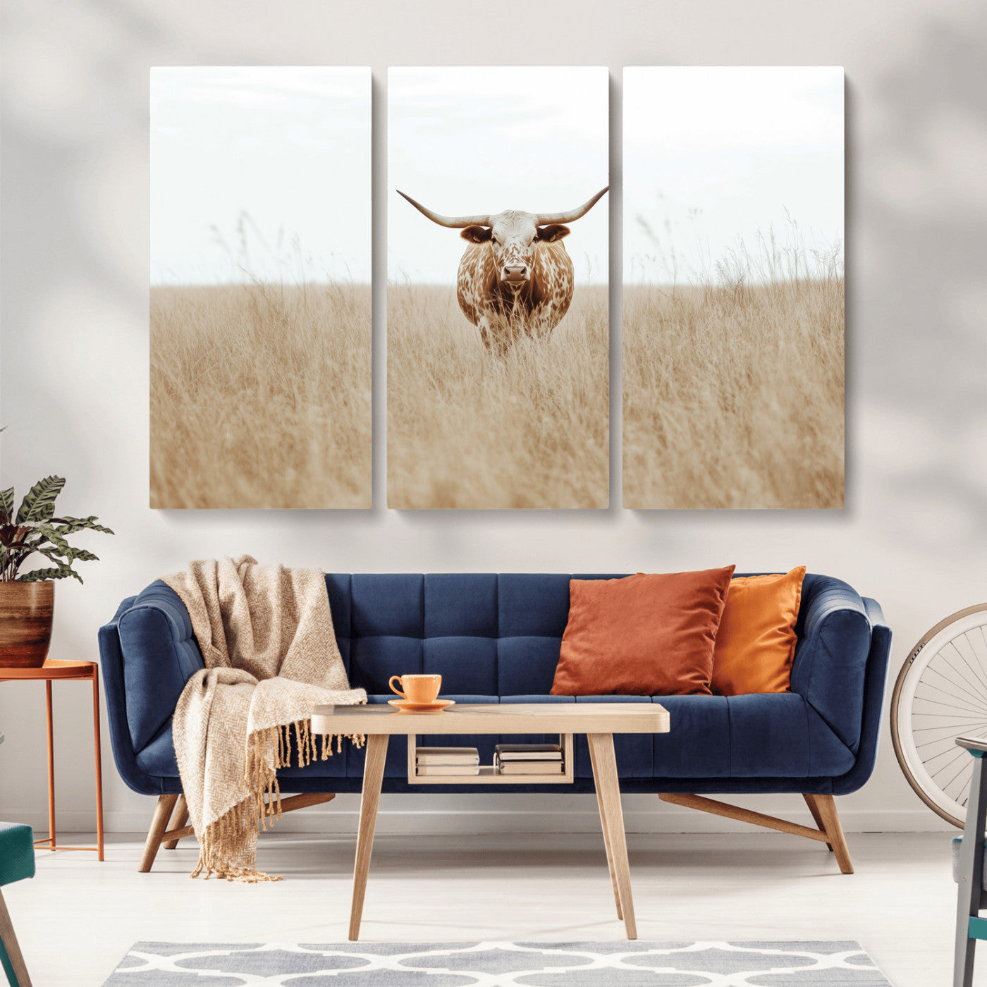 Texas Longhorn bull standing alone in dry grass with neutral tones, ideal for rustic western or cowboy-themed wall decor.
