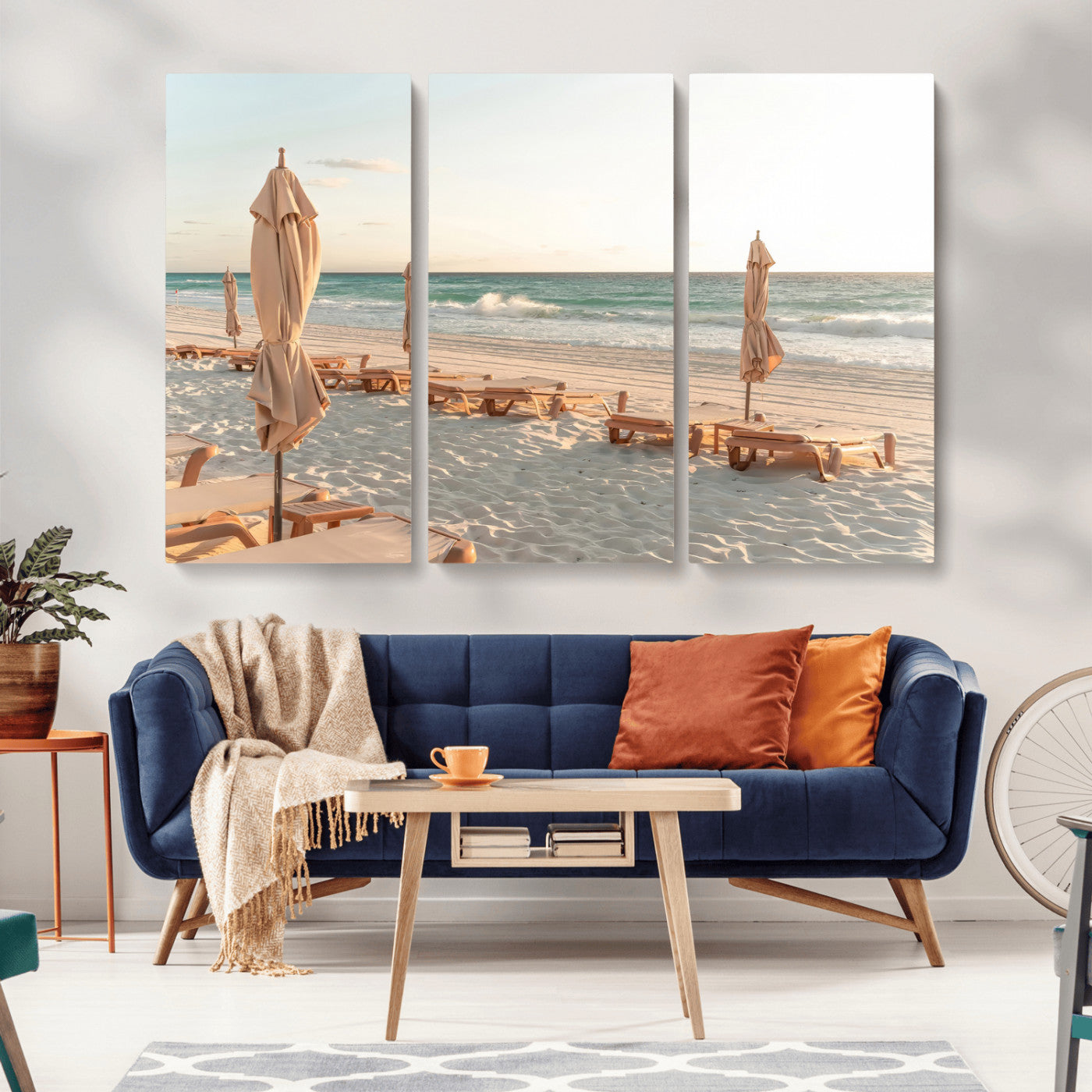 Minimalist photo of empty beach loungers and umbrellas on soft sand, ideal for calm seaside or pastel coastal-style home decor.