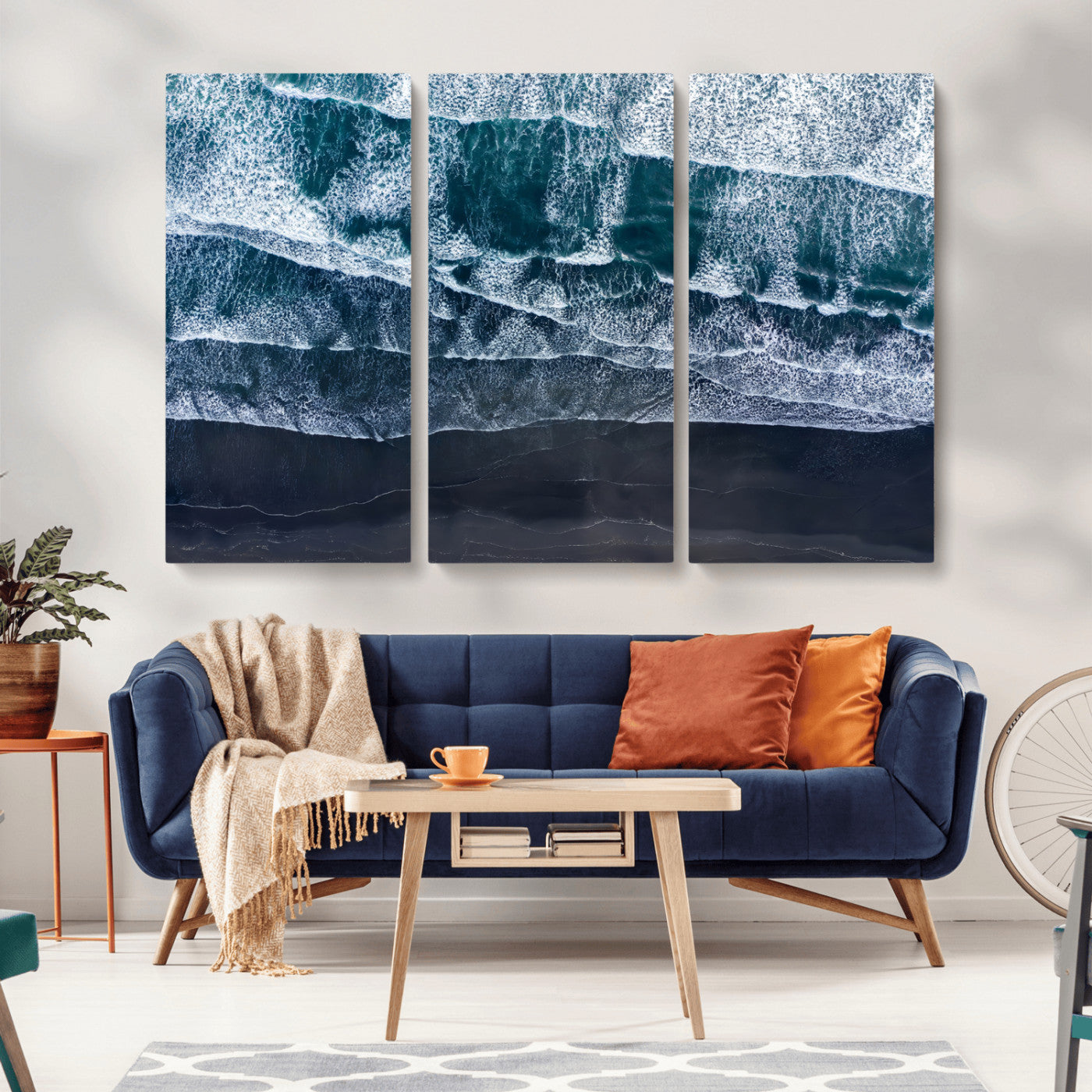 Canvas of aerial ocean waves crashing onto a black sand beach in moody tones, ideal for modern coastal or minimalist home decor.