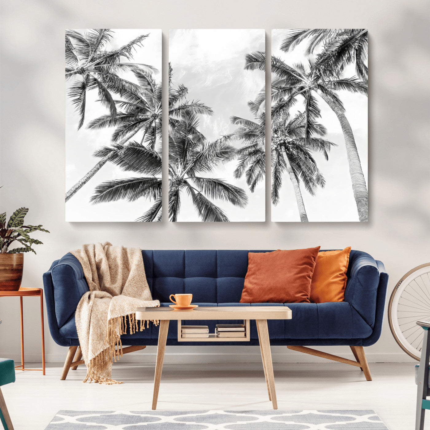 Black and white tropical palm trees viewed from below, swaying gently against a bright sky, creating a serene and elegant coastal atmosphere.