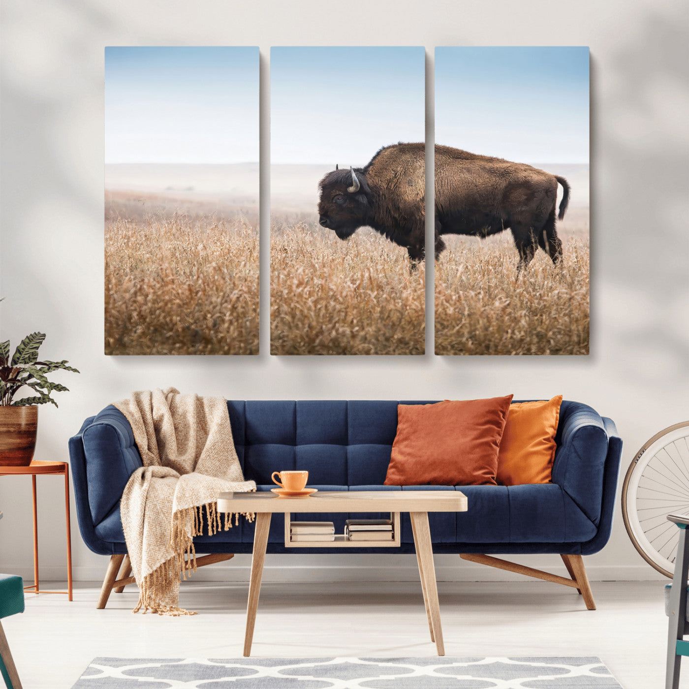 A majestic bison standing in an open prairie field, its strong form blending into the golden grass under a vast blue sky, evoking the wild spirit of the American plains.