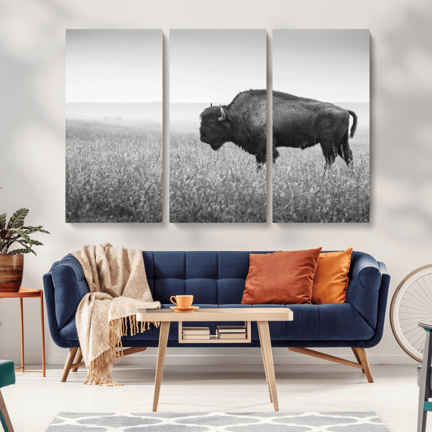 A black and white photograph of a majestic bison standing in a vast grassy prairie, evoking a sense of wilderness and strength.