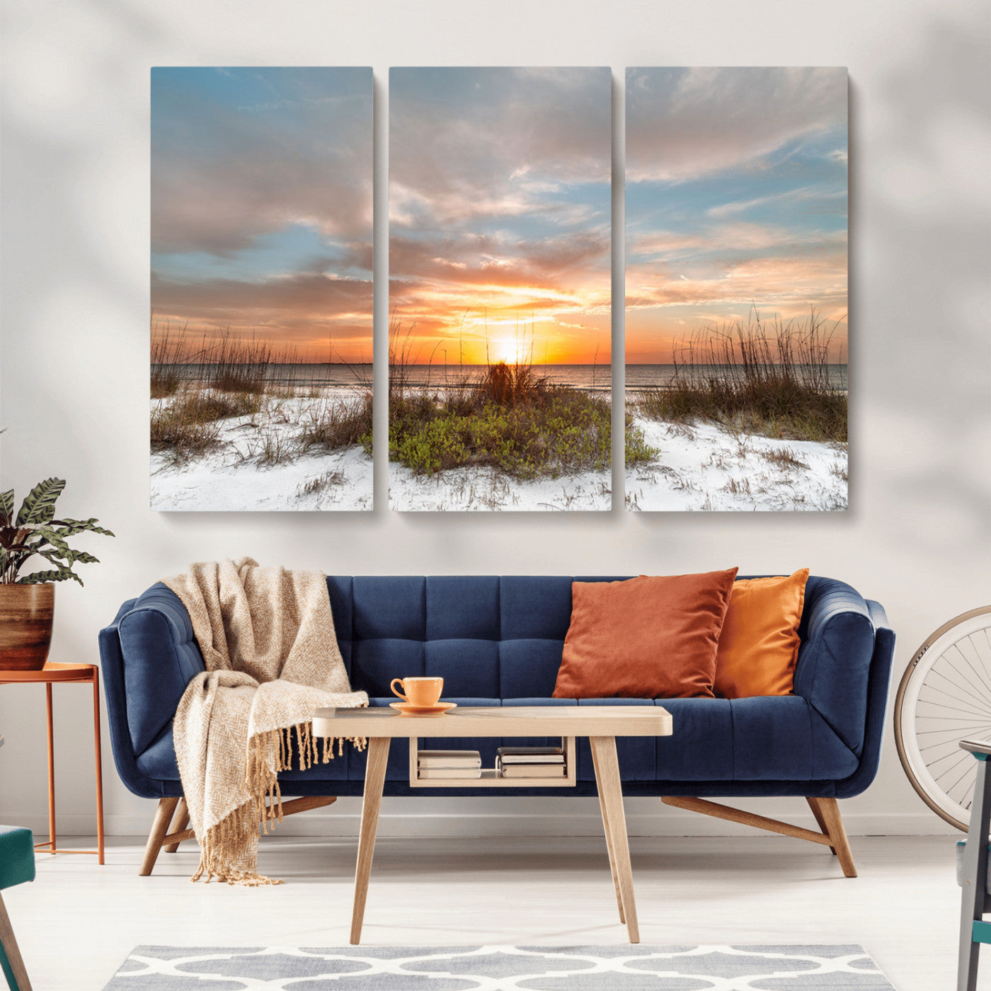 A tranquil beach scene featuring golden sunset hues over the water, with grasses in the foreground and a peaceful, serene atmosphere.