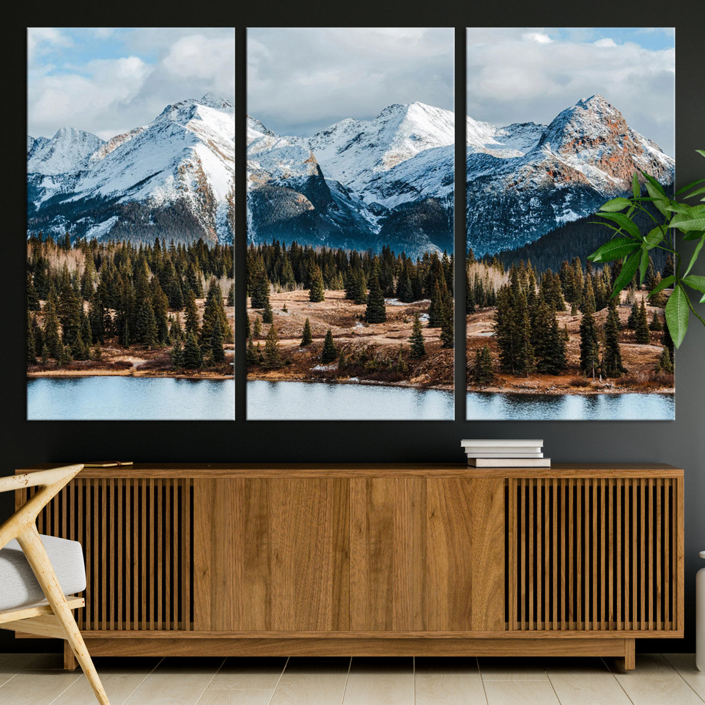 Framed canvas of snowy mountain peaks with pine forest and alpine lake, perfect for winter cabin or wilderness-inspired home decor.