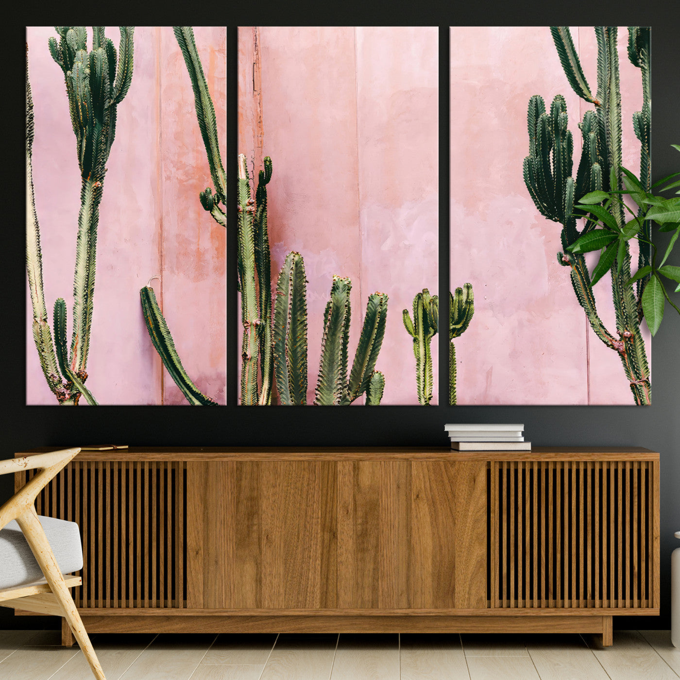 Framed canvas of tall green cacti against a soft pink wall, ideal for modern desert or colorful southwest-inspired home decor.
