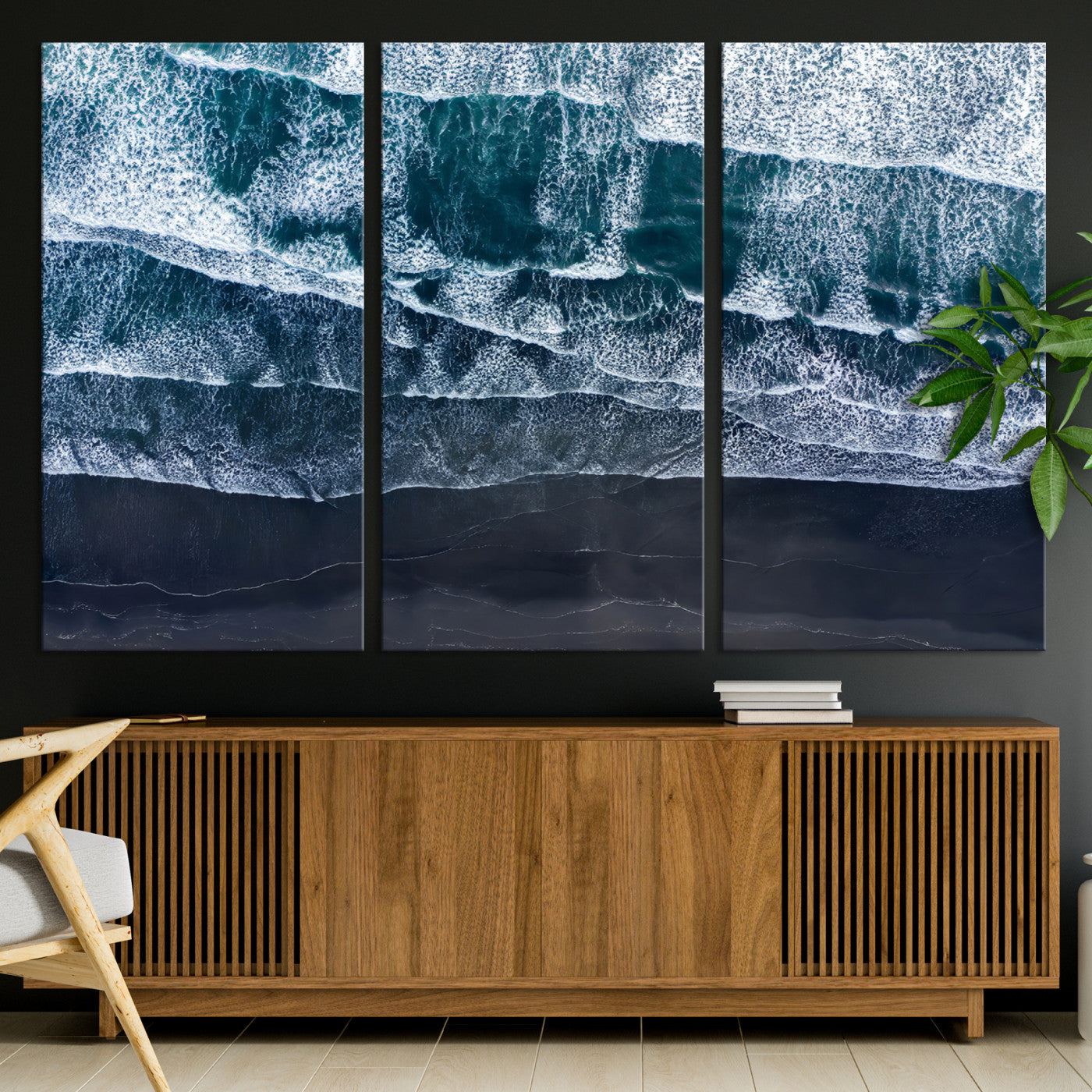 Canvas of aerial ocean waves crashing onto a black sand beach in moody tones, ideal for modern coastal or minimalist home decor.