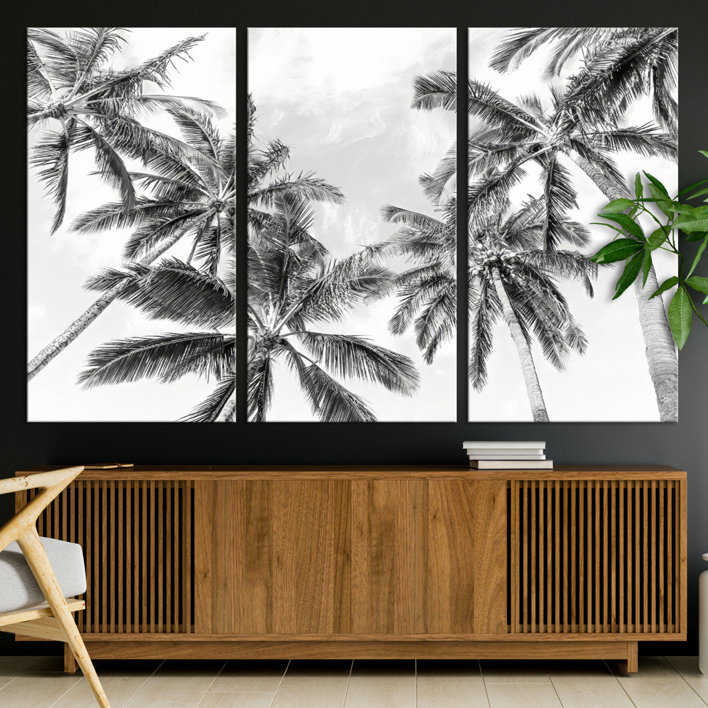 Black and white tropical palm trees viewed from below, swaying gently against a bright sky, creating a serene and elegant coastal atmosphere.