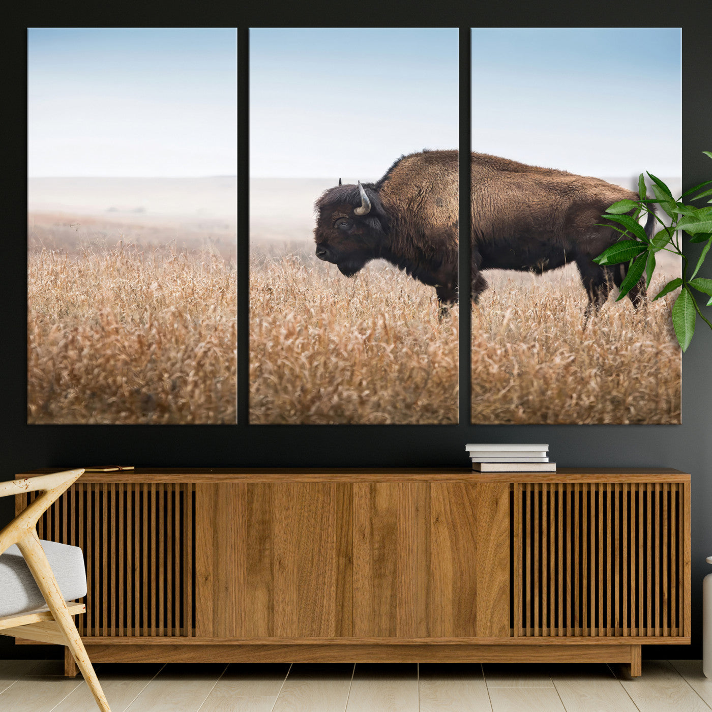 A majestic bison standing in an open prairie field, its strong form blending into the golden grass under a vast blue sky, evoking the wild spirit of the American plains.